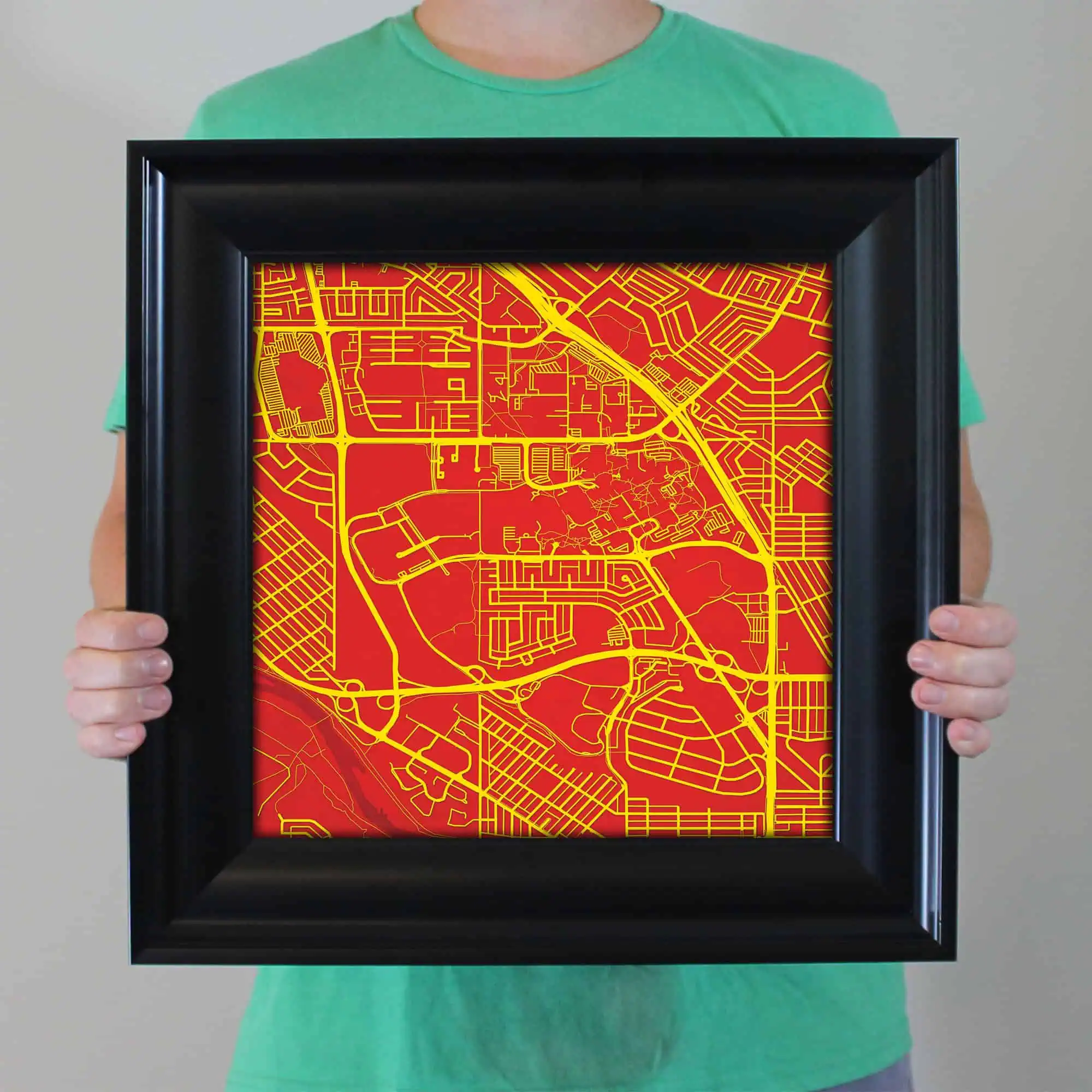 Map of urban streets with highlighted roads in yellow on a red background, framed for display.