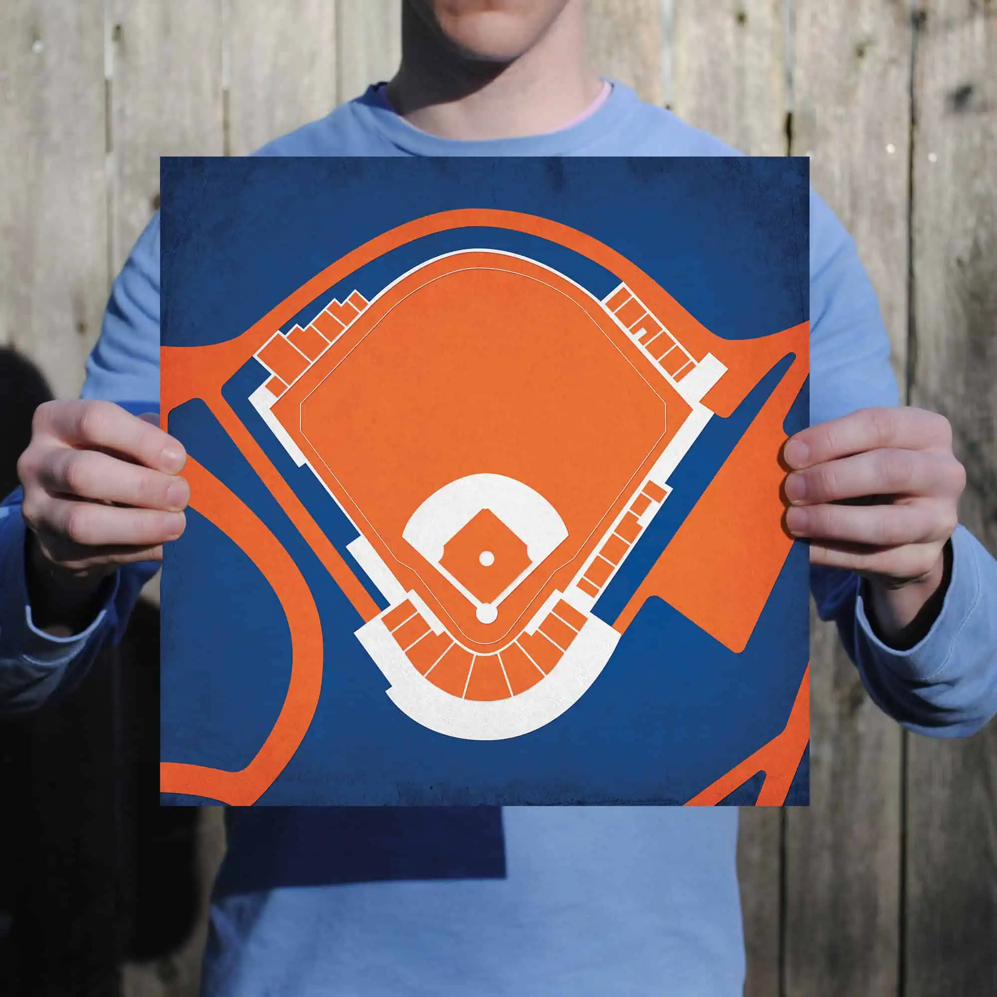 Colorful baseball field map graphic held by person, showcasing sports and recreation mapping, ideal for sports enthusiasts., Baseball field diagram with vibrant colors representing sports layout, held outdoors by a person promoting sports maps and recreation planning., A person holding a stylized, colorful map of a baseball field, featuring vibrant orange, white, and blue colors, emphasizing sports, recreation, and outdoor activity planning.