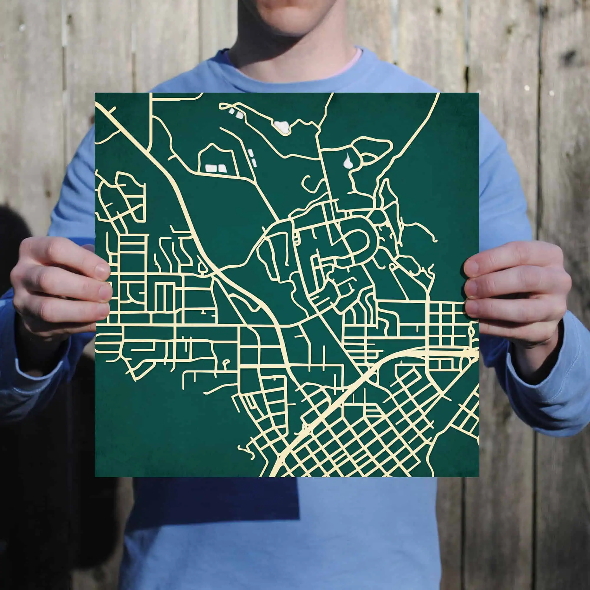 Detailed city street map held by a person, showcasing urban road layouts and routes for navigation and exploration.