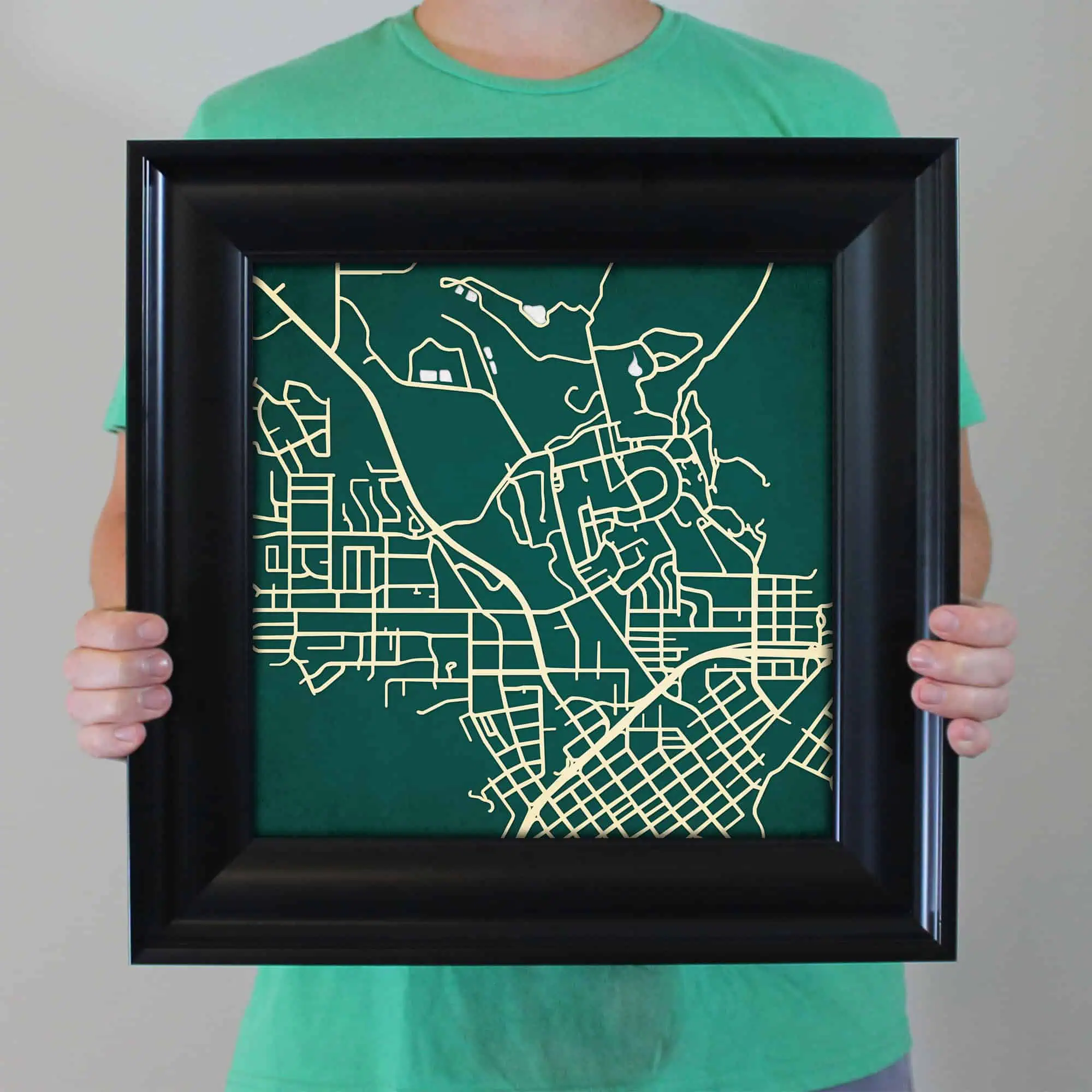 Detailed map artwork displayed in a black frame, showcasing an intricate city street and road layout. Perfect for travel planning, navigation, or as a decorative piece for map enthusiasts.
