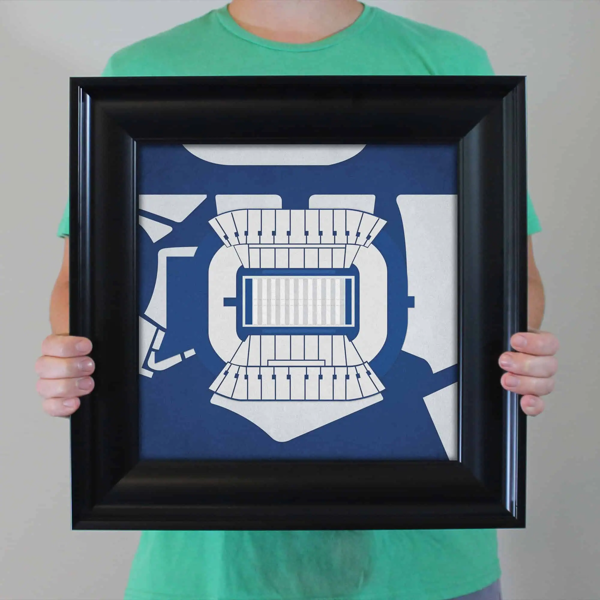 Stadium seating chart illustration in a frame held by a person wearing a green shirt, emphasizing sports venue maps, seating arrangements, and stadium layouts. Perfect for sports, event planning, and venue navigation.