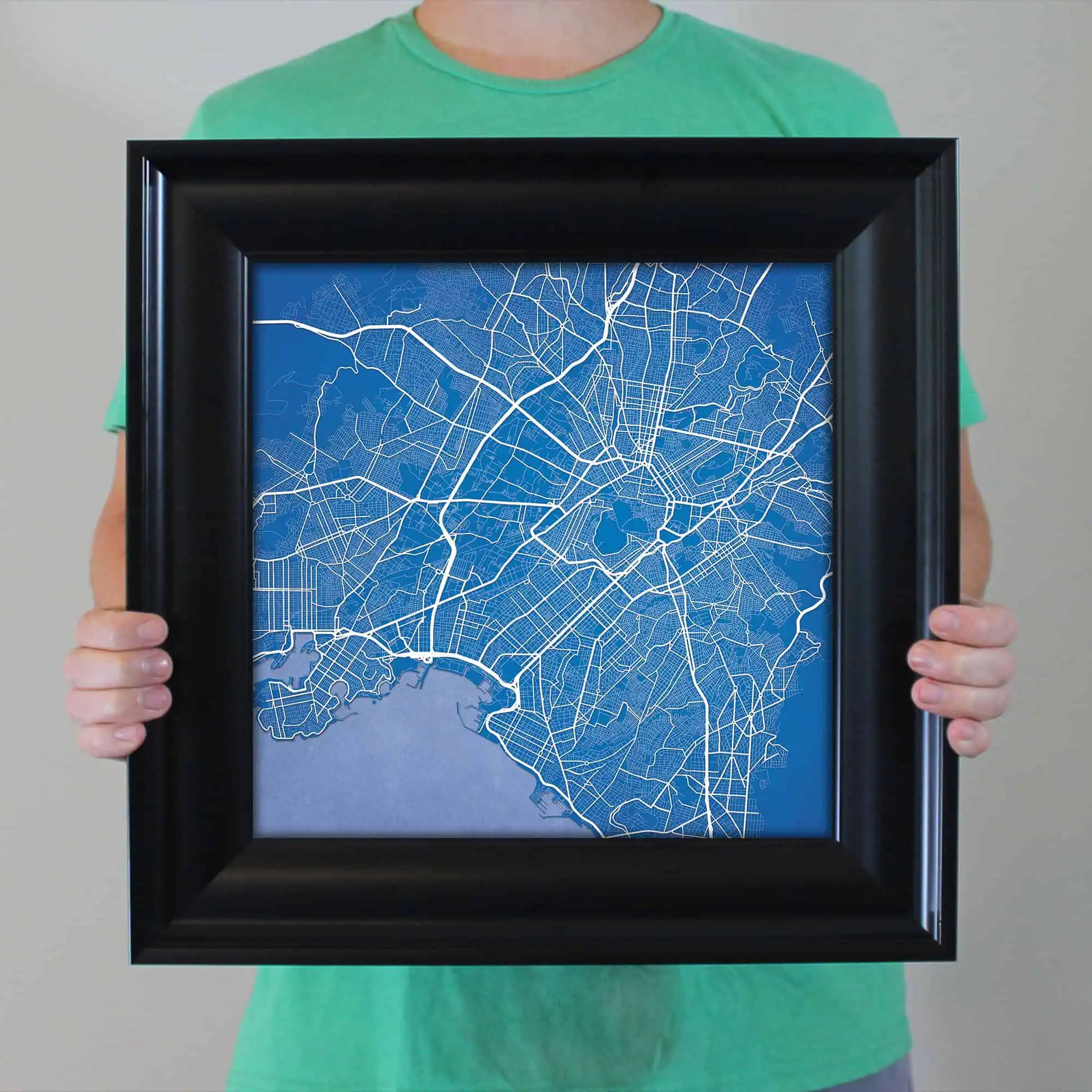 Detailed street map of a city with blue background, showcasing roadways and geographic layout.