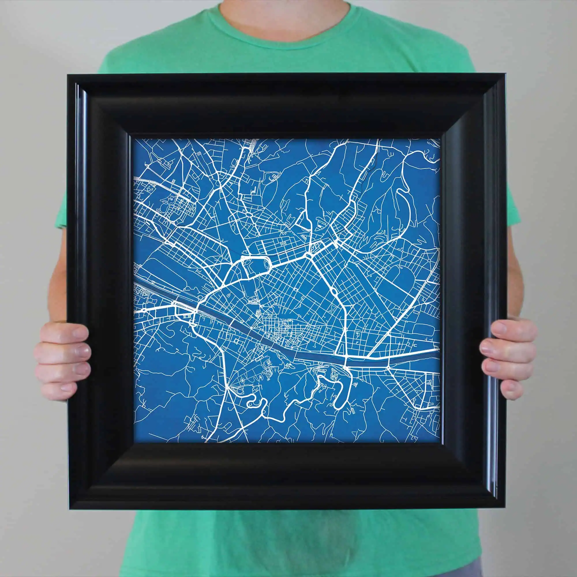 Map of a city with street outlines in white on a blue background, framed in black.