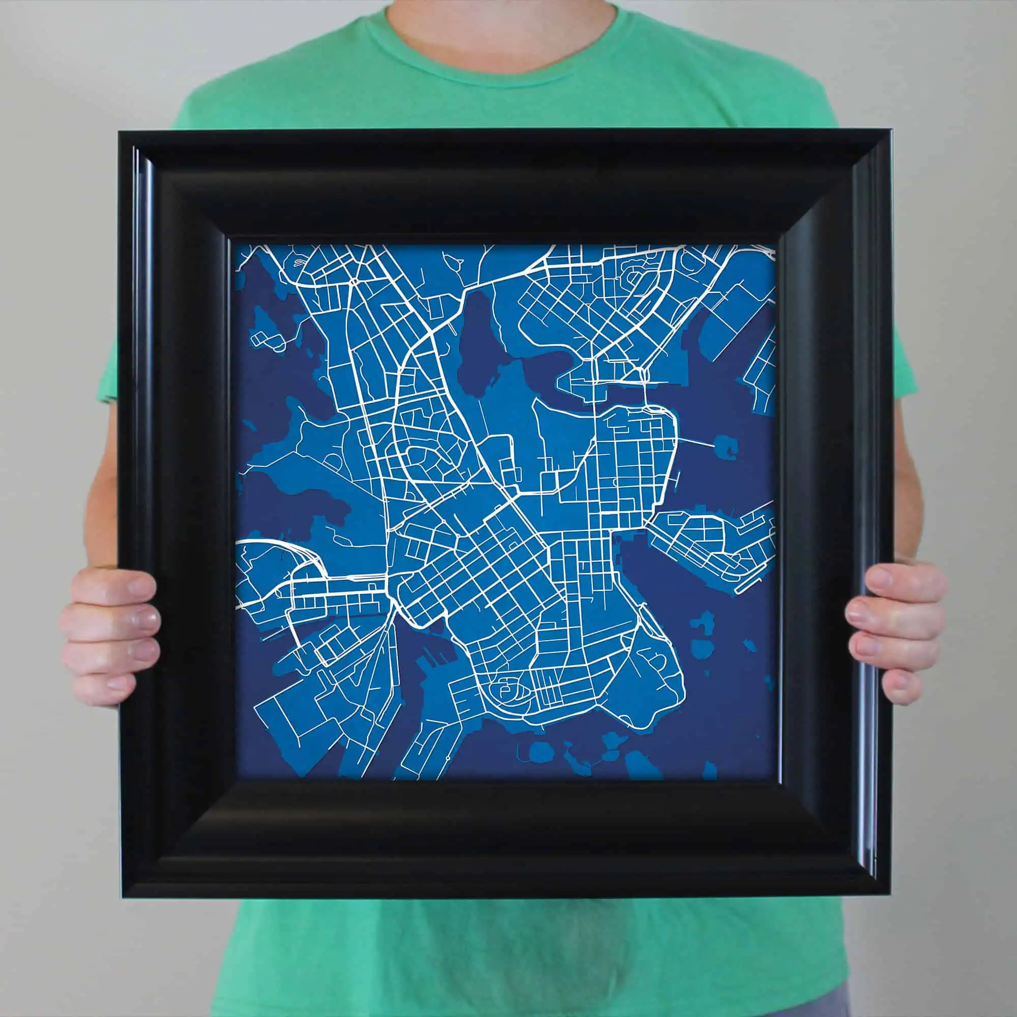 Map of Seattle displayed in a black frame, showcasing detailed street layout and waterways, perfect for navigation, travel planning, or home decor.