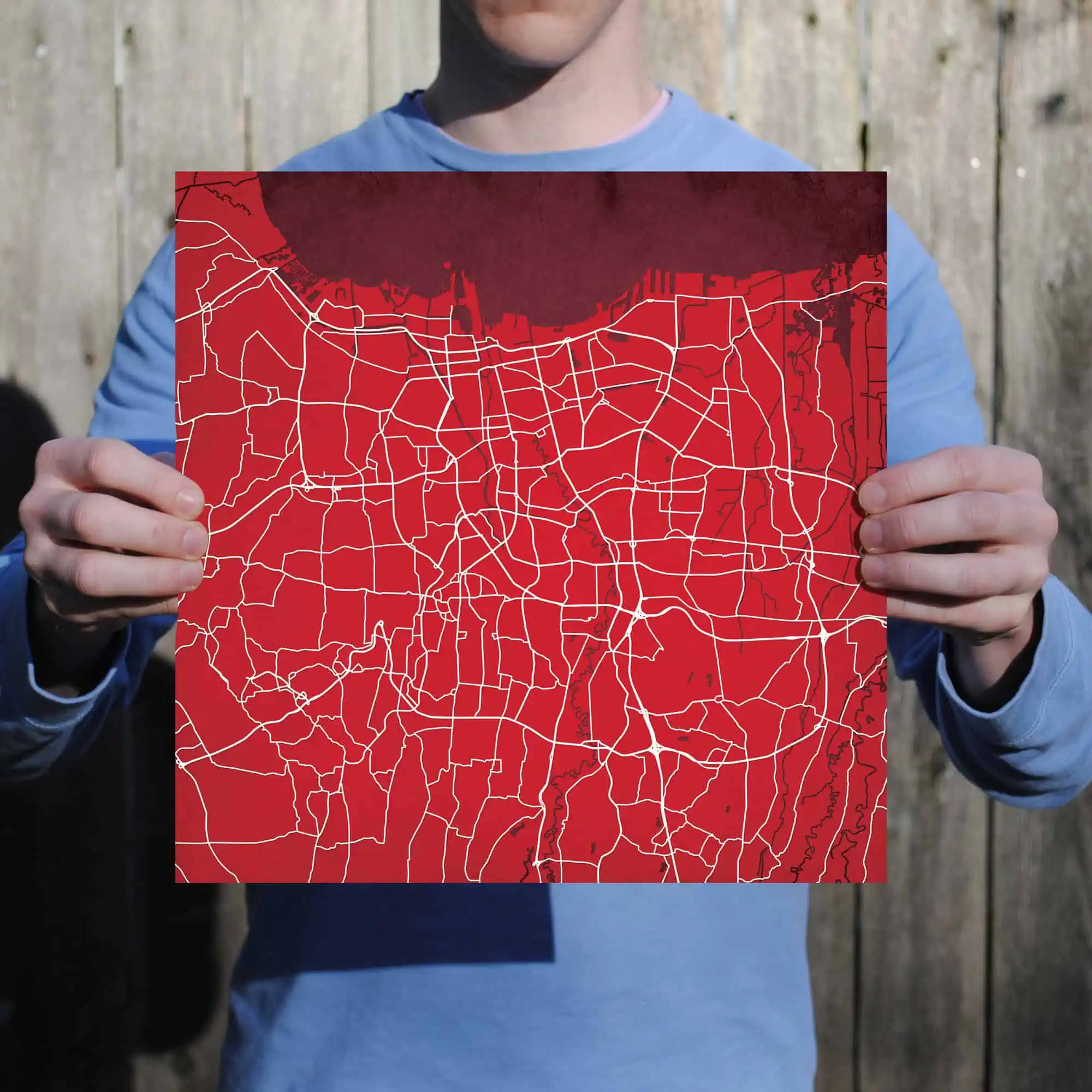 Detailed city street map held by a person, showcasing urban navigation and GPS route planning. Perfect for travel, navigation, and mapping services.