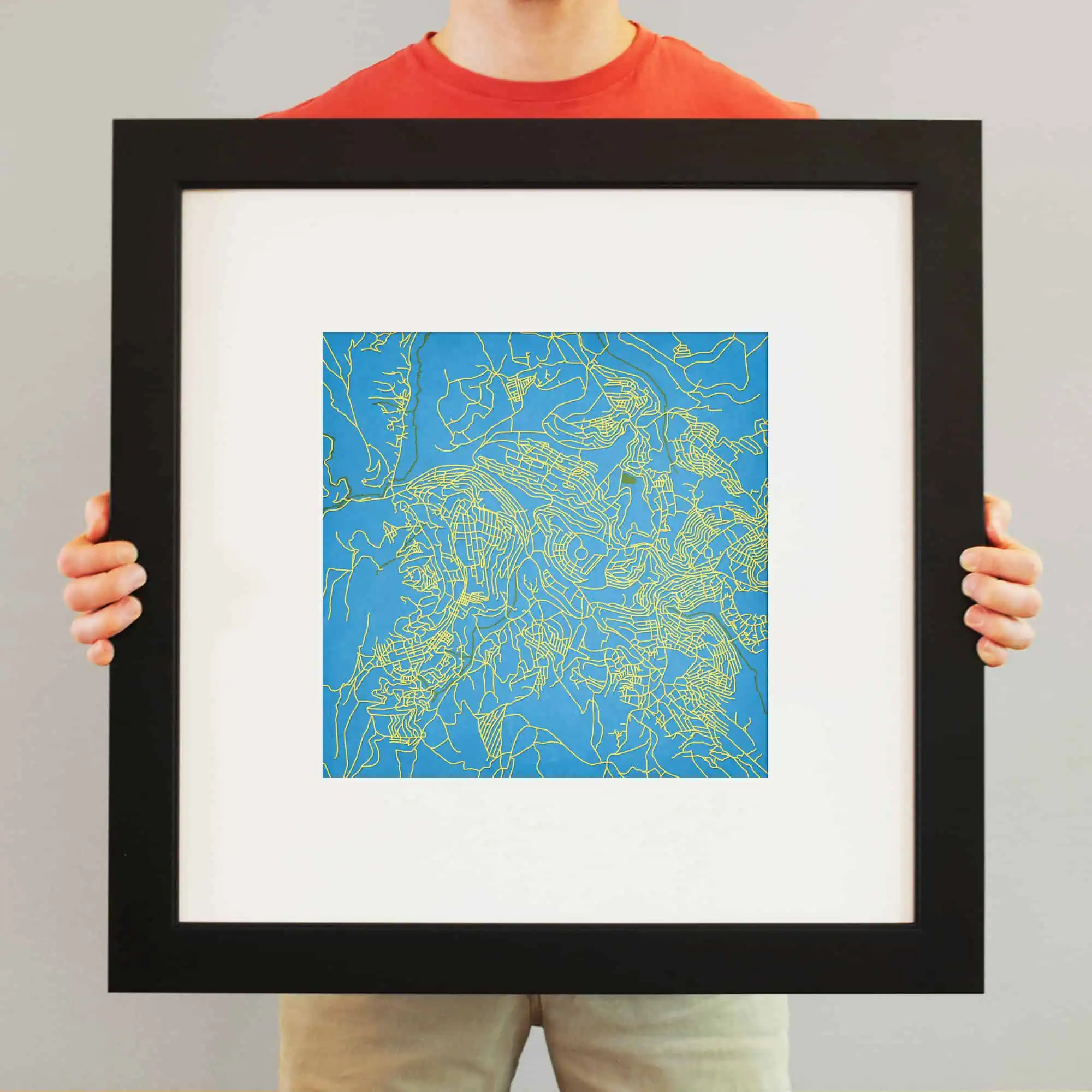 Detailed map artwork featuring vibrant blue and yellow lines representing city streets and landscapes for wall decor.