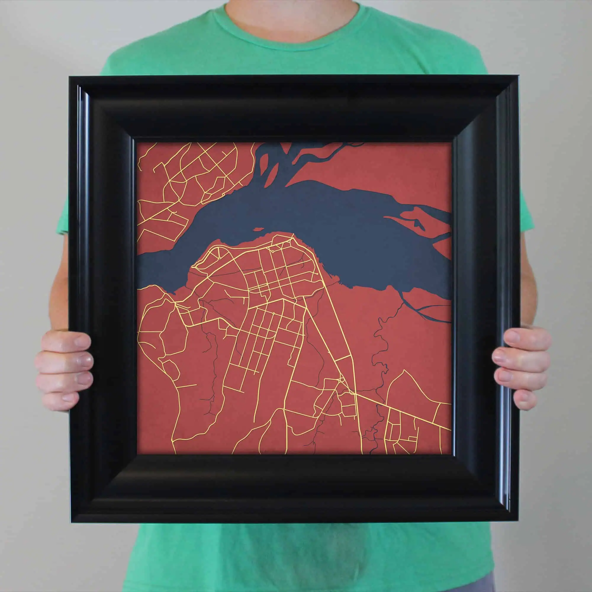 Vivid map artwork depicting a city layout with bold blue water features, layered with gold street lines on a red background, framed in black for a striking artistic presentation.