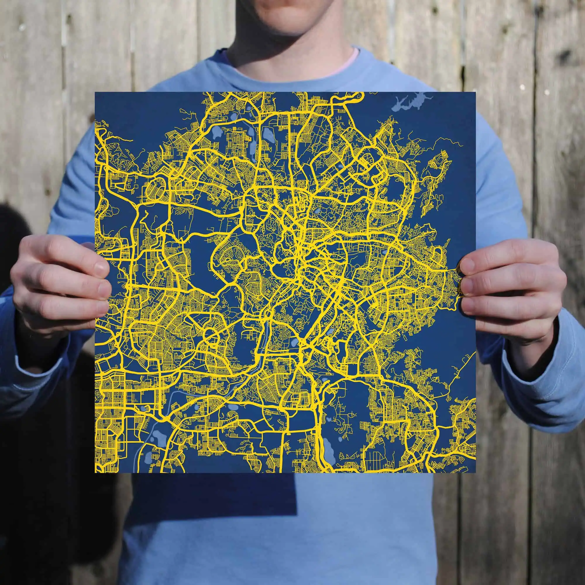 Detailed city map with yellow streets on a dark background, showcasing the urban layout and road network.