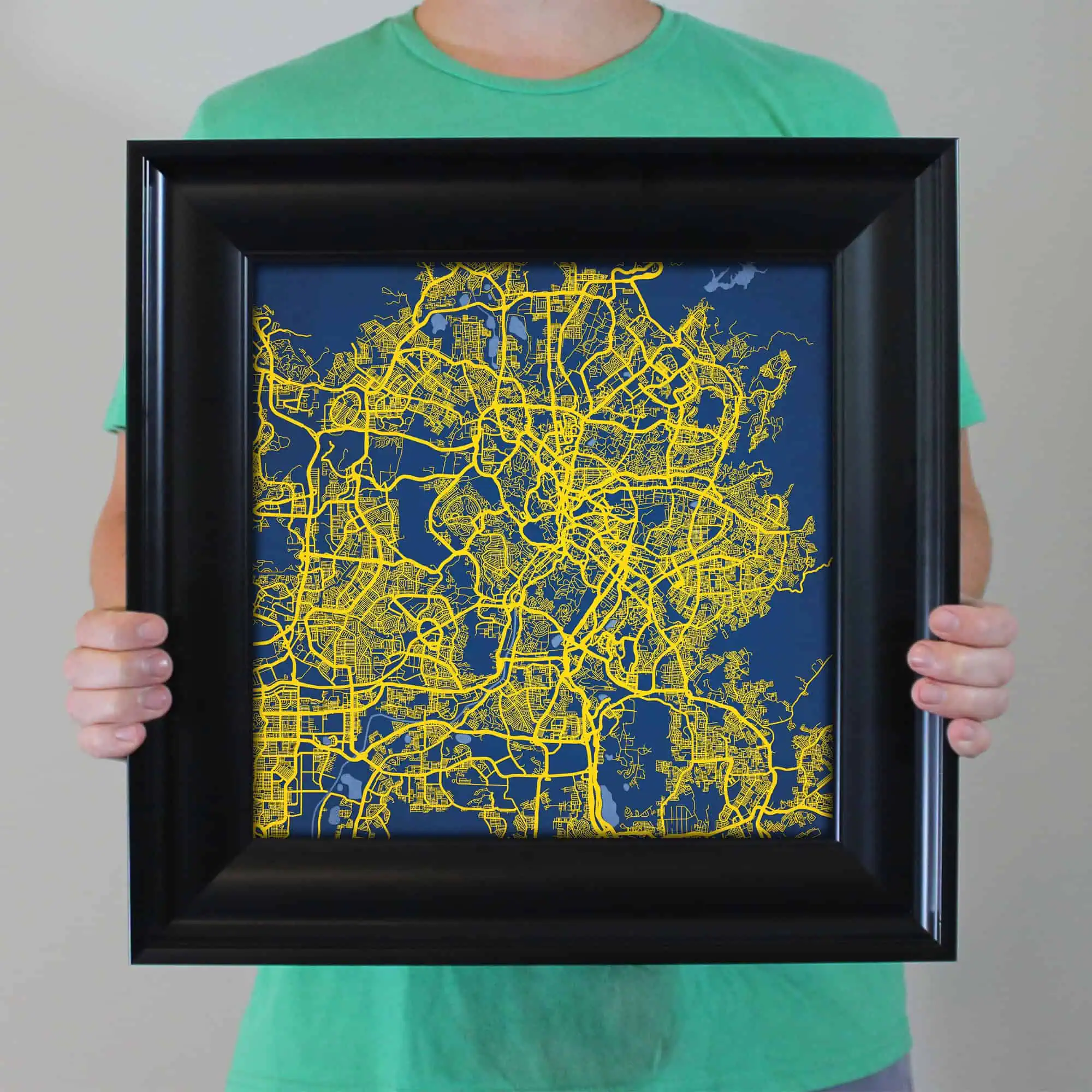 Colorful city map art framed print showcasing detailed urban street layouts in yellow on a blue background. Perfect for city enthusiasts, travelers, and map collectors to display stylish geographic decor.