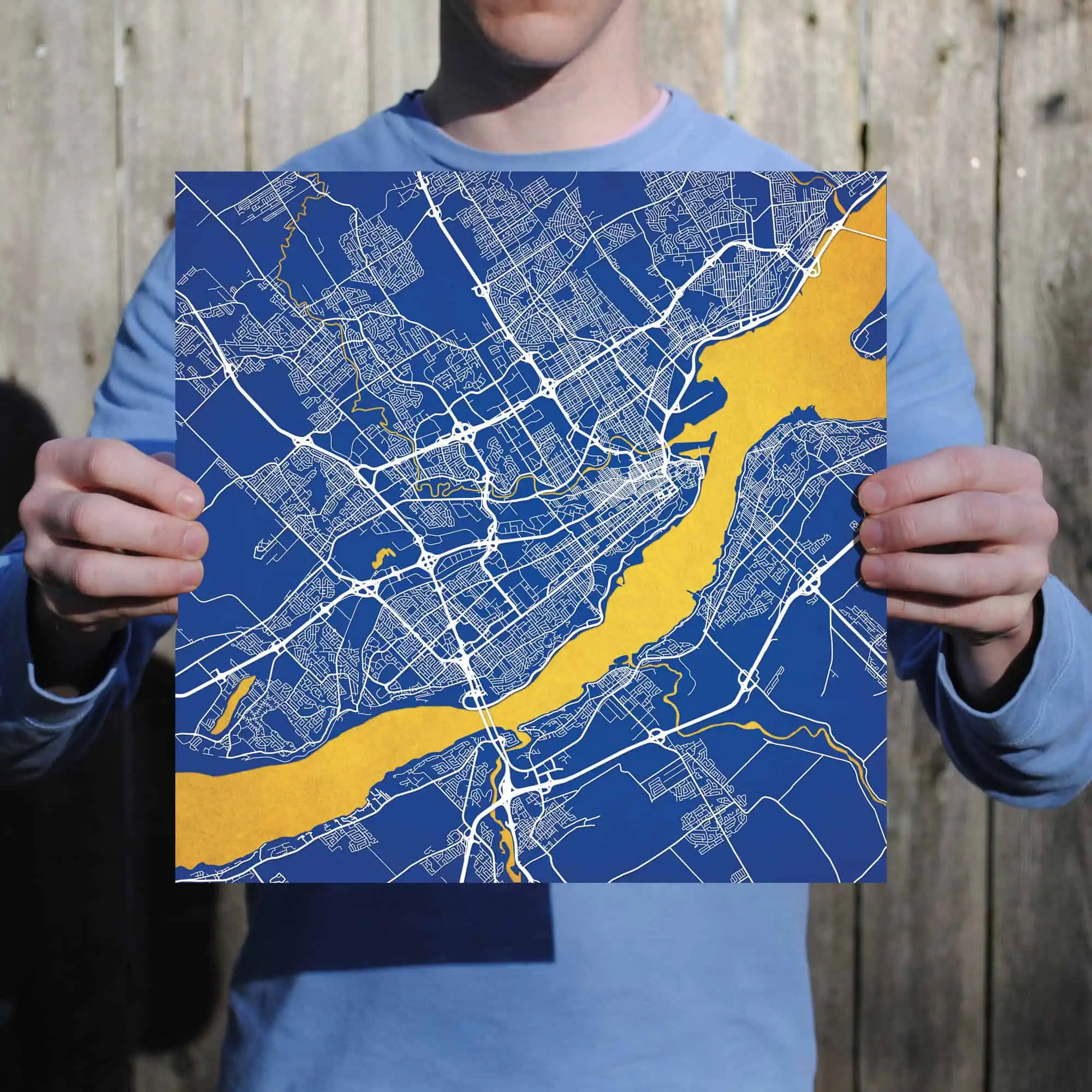 Map of a city with blue background, white roads, and yellow highlighting a river or water body.