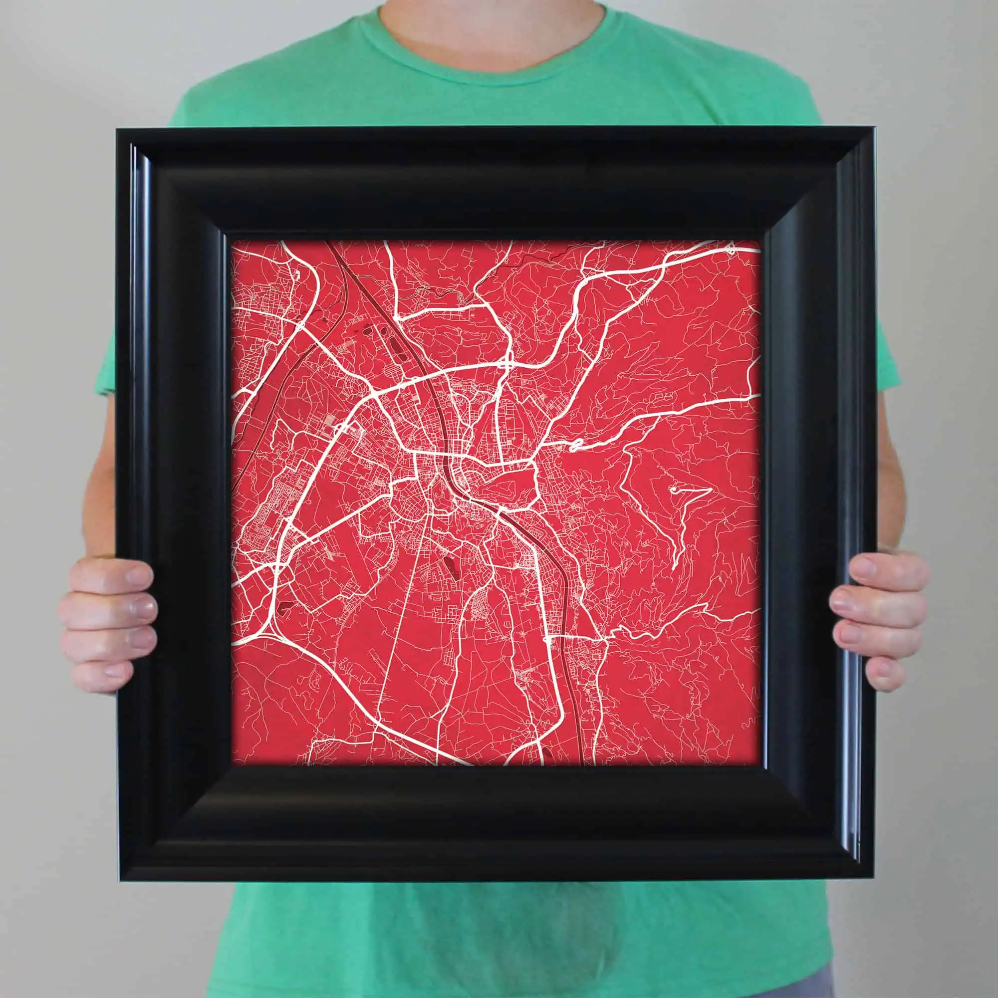 A map of a city with detailed road networks displayed inside a black frame, showcasing urban and suburban routes, ideal for navigation and travel planning.