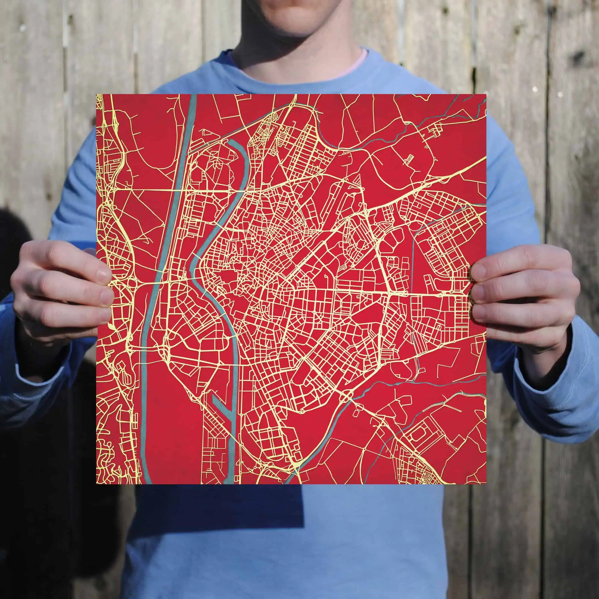 Detailed city street map with river details on red background, ideal for navigation, travel planning, and geographic reference.