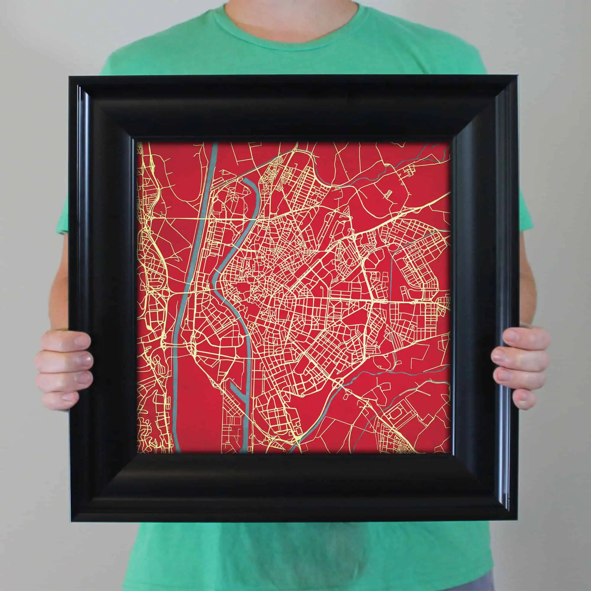 A detailed city map with streets and waterways displayed on a red background, framed for decorative or navigation purposes, perfect for map enthusiasts and travelers.