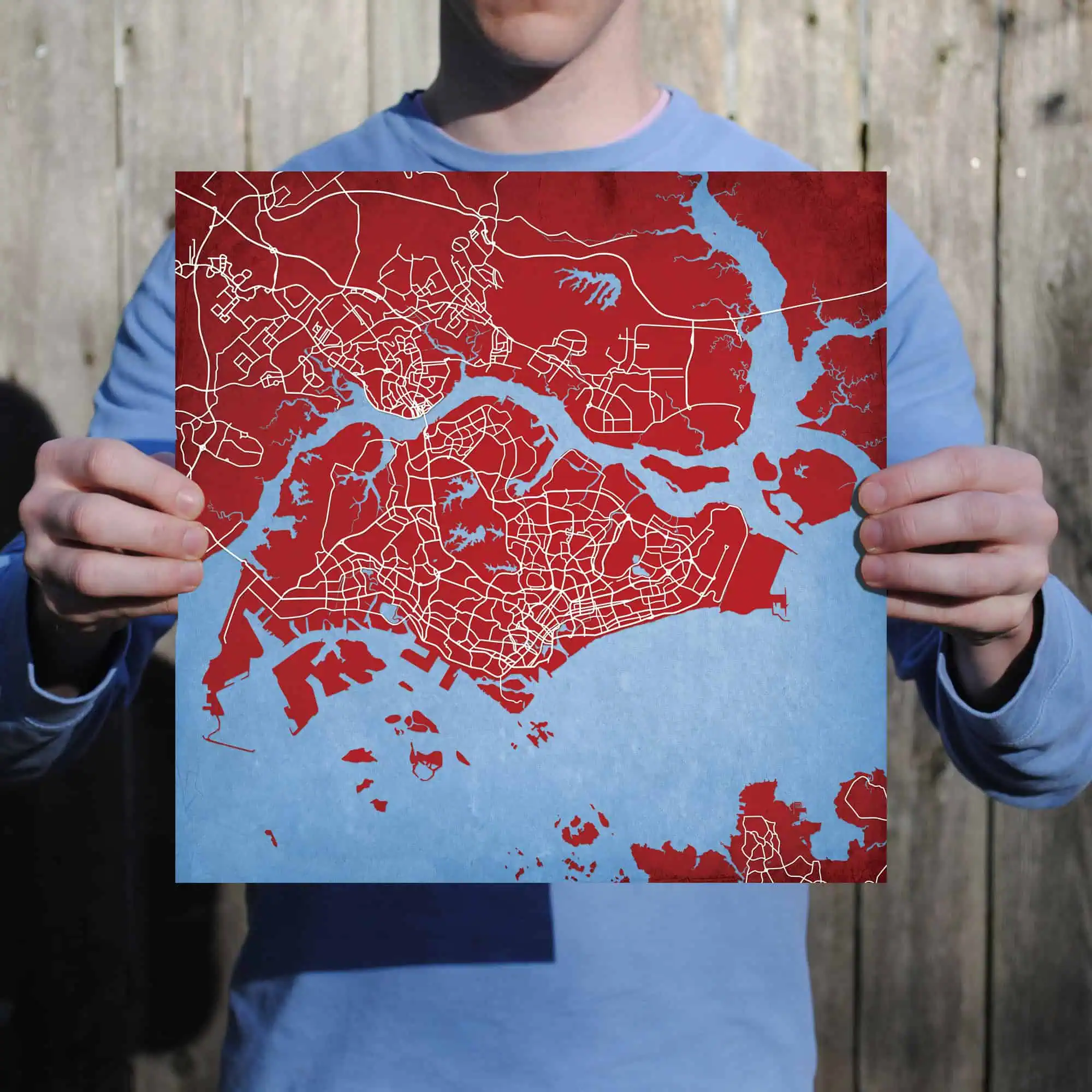Detailed city map print with waterways and street layouts, perfect for travel planning and navigation, showcased by a person holding the map outdoors.