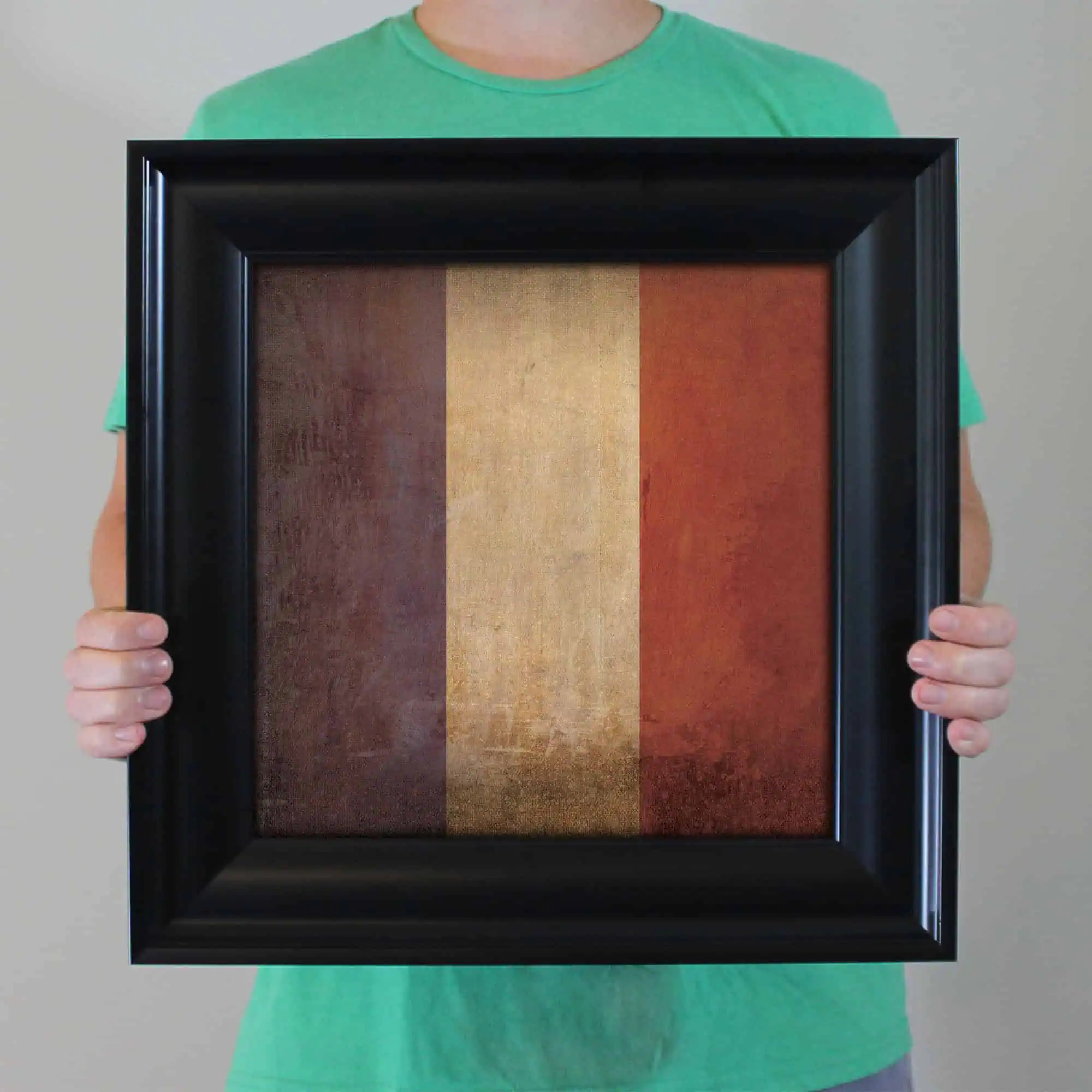 A framed artistic artwork featuring the colors of the Belgian flag with black, yellow, and red vertical stripes, perfect for home or office decor.