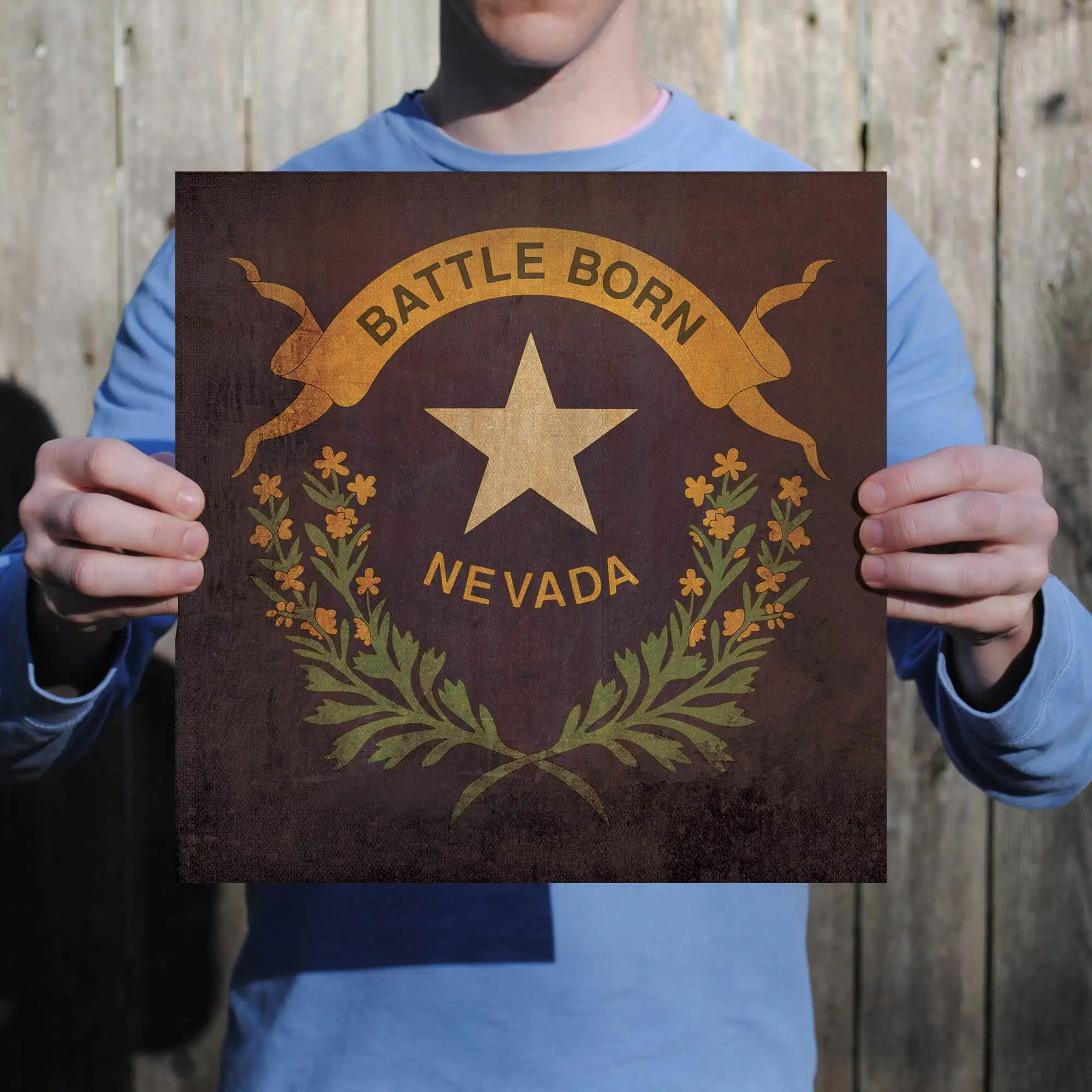 Vintage Nevada state emblem poster with "Battle Born" slogan, featuring a star and decorative floral wreath, ideal for travel and state pride memorabilia.