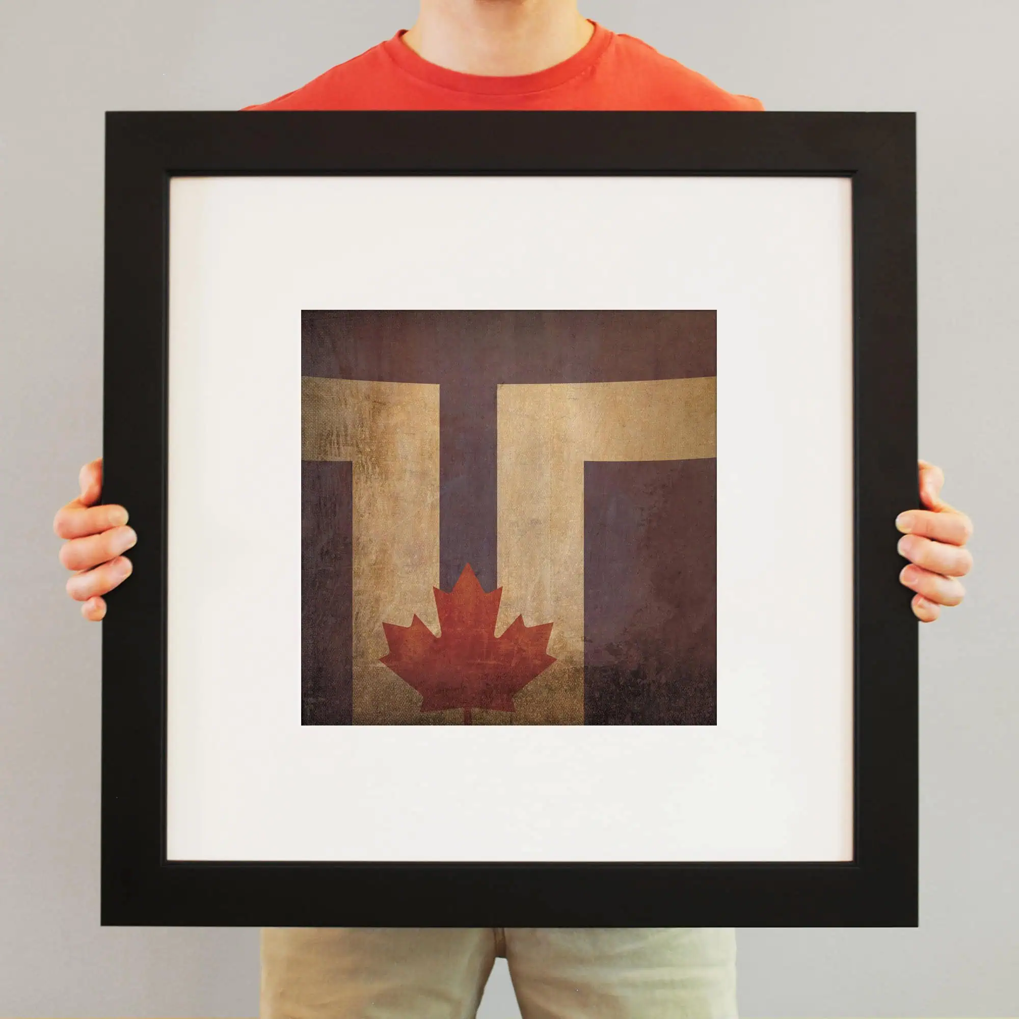 Vintage Canadian flag artwork framed print, featuring the maple leaf and stylized "T" design, perfect for Canadian pride, art collection, or home decor.