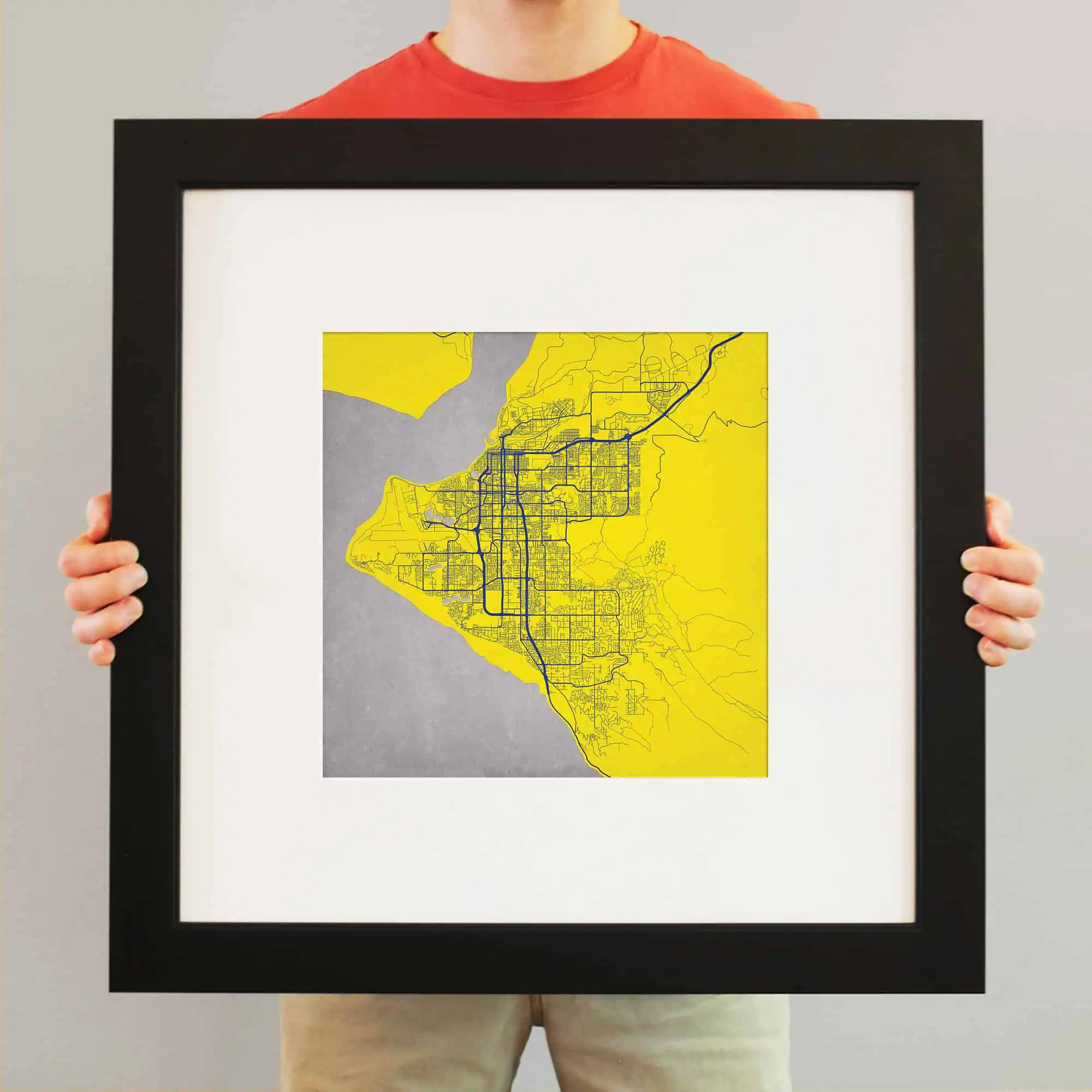 Colorful city map illustration featuring detailed streets and geographic features displayed in a black frame for home or office decor.