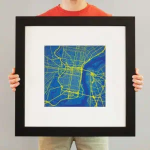 Vivid city map artwork in a black frame showcasing urban street layouts and waterways, perfect for home decor or office spaces.