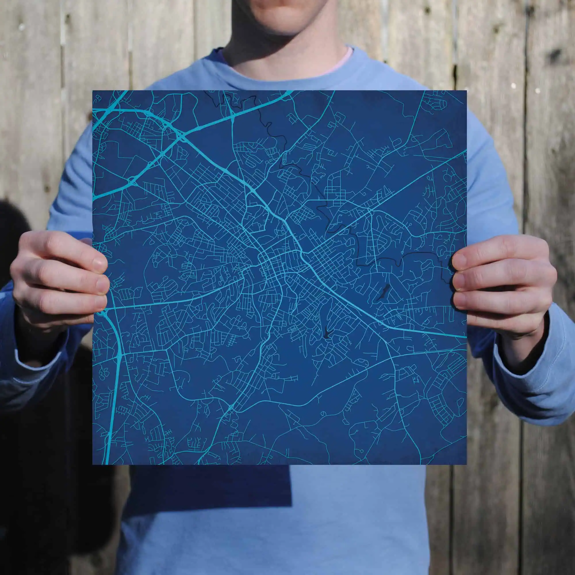 Detailed city map held by a person, showcasing urban street layout for travel and navigation planning.