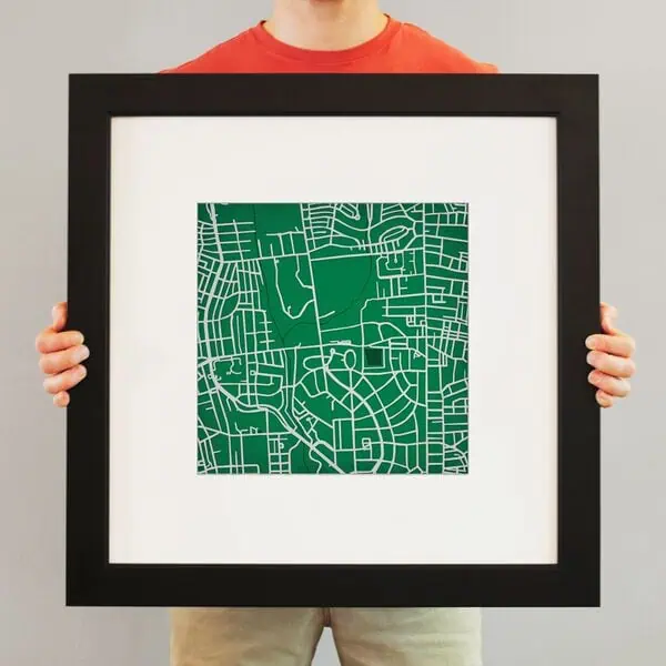 Colorful modern map art print in a black frame, ideal for home or office decor, showcasing detailed street layouts and urban designs for geography and navigation enthusiasts.