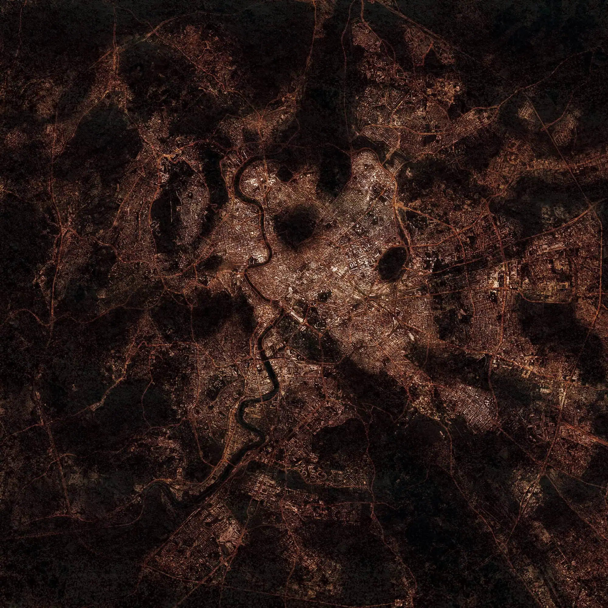 Detailed satellite image of a city illuminated at night with visible roads and river patterns, perfect for maps, navigation, and geographic analysis.