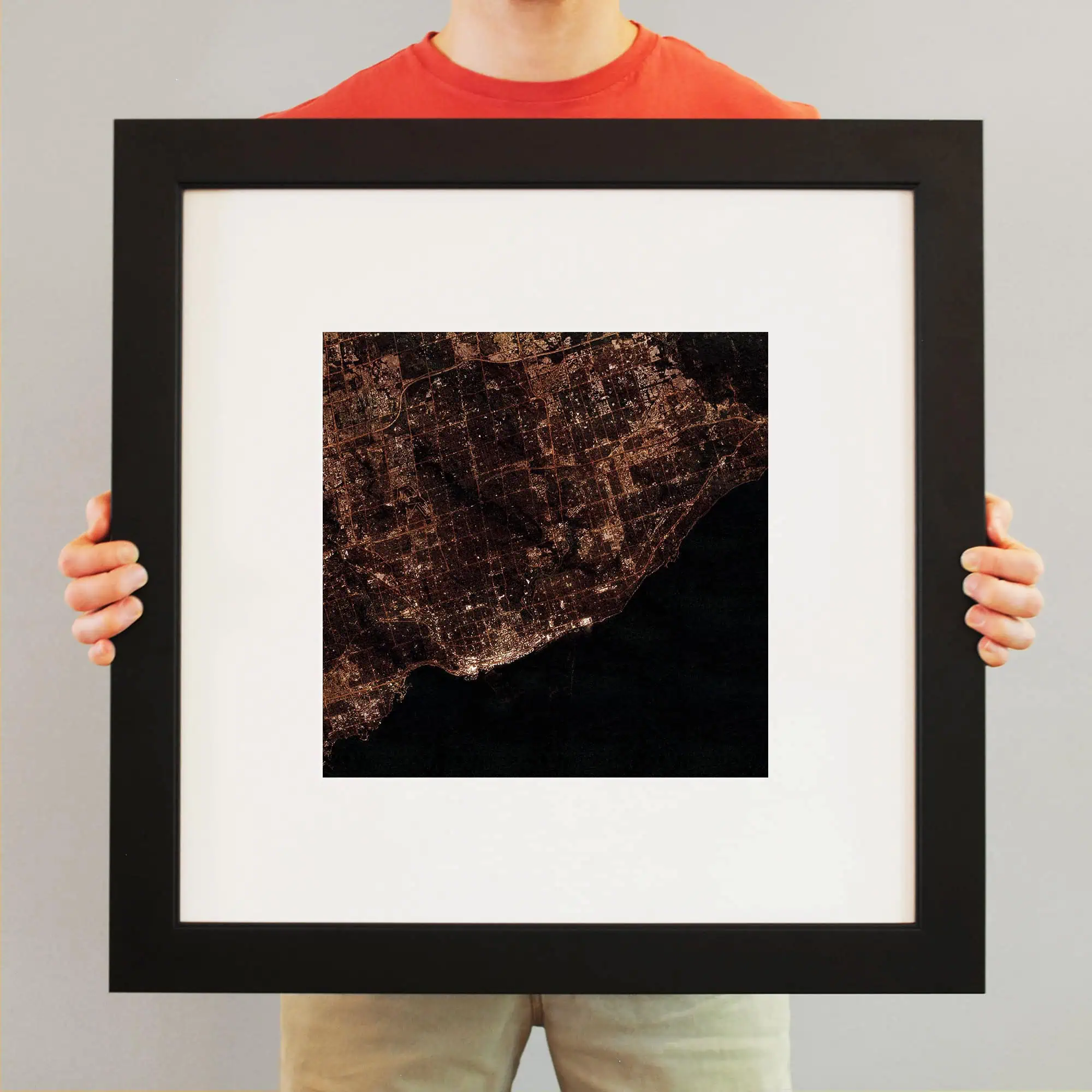 Aerial night view of a city with illuminated streets and coastline, showcasing detailed urban mapping and satellite imagery. Perfect for cartography and geographic display purposes.