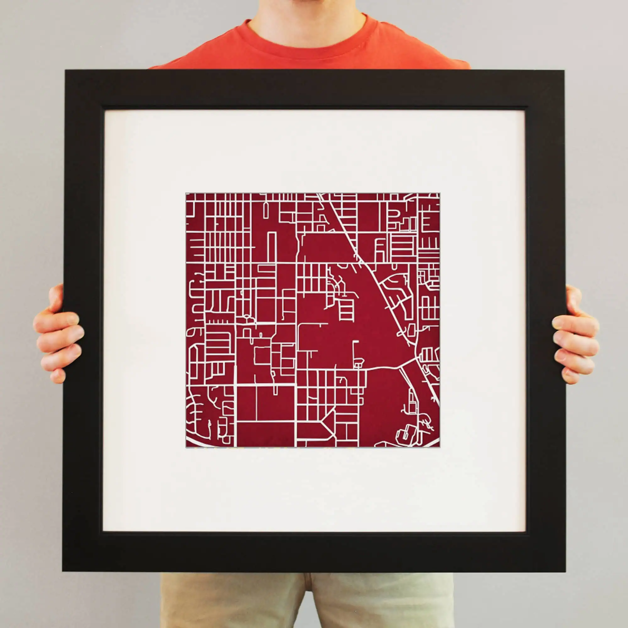 Colorful map artwork of a city street grid, displayed in a sleek black frame, perfect for home or office decor.
