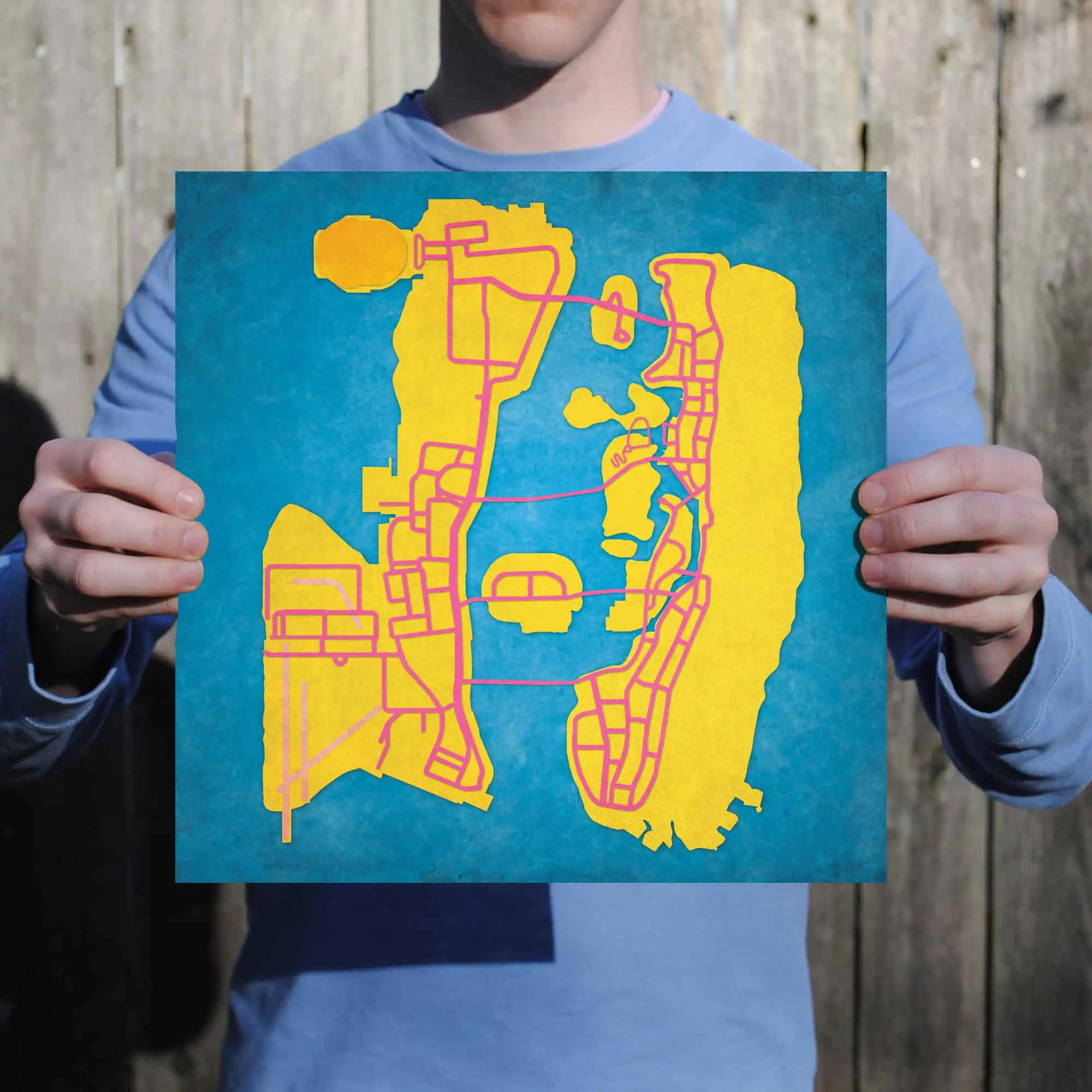 Map shop map of a city with streets and waterways, held by a person outdoors.