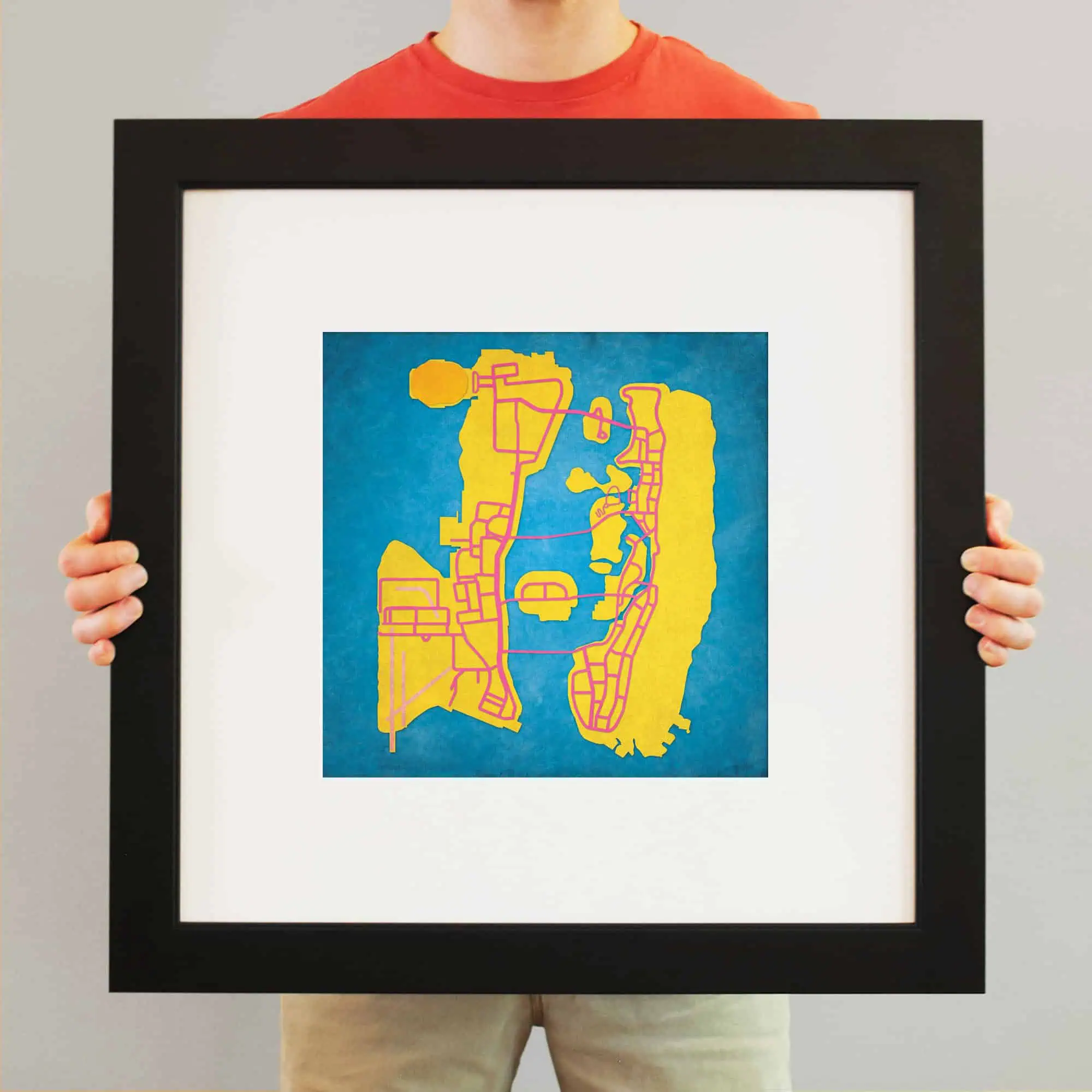 Colorful city map artwork framed print, vibrant yellow, pink, and blue map design, perfect for home or office decor, showcasing detailed urban neighborhoods and streets.