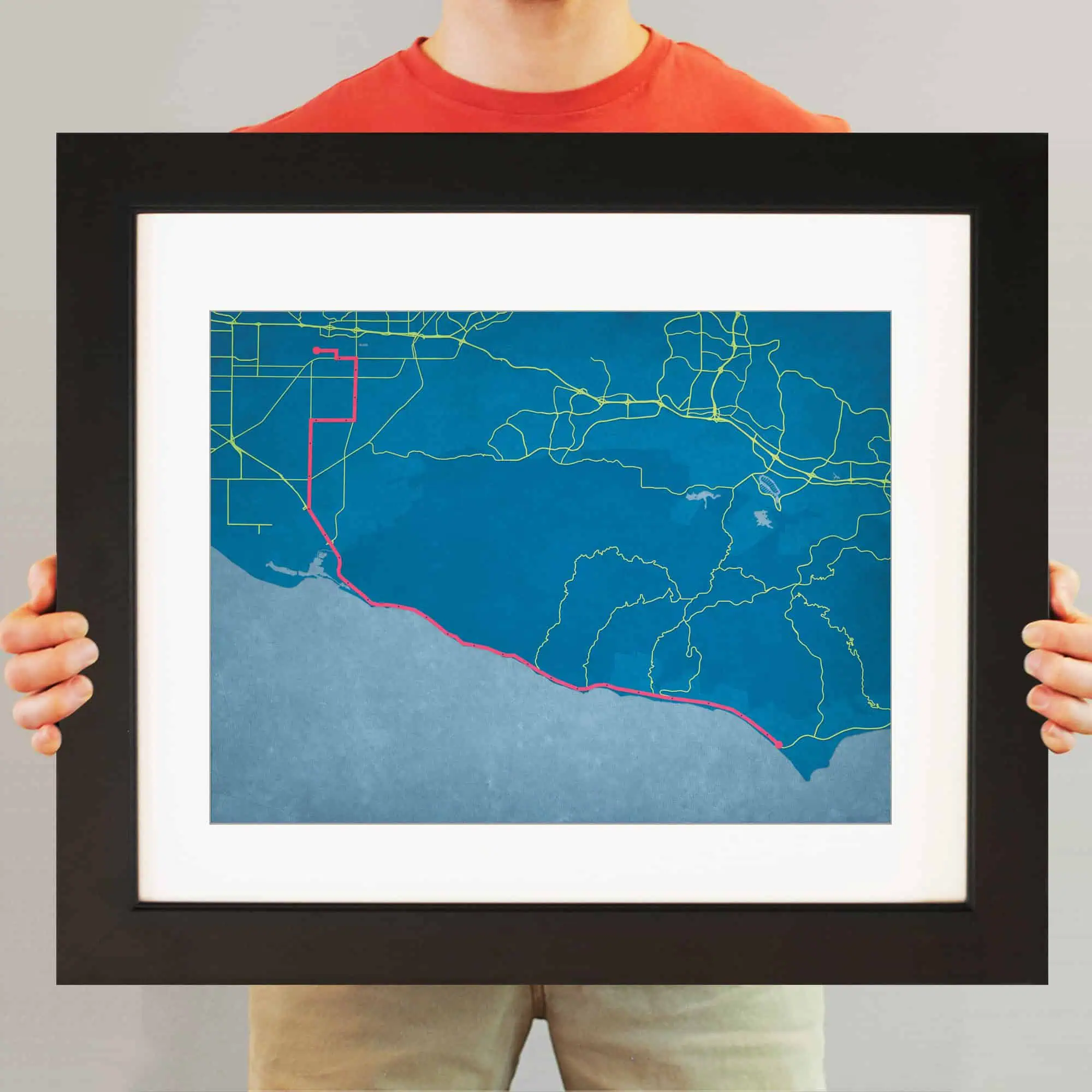 Deep blue coastal map with a highlighted pink route, showcasing navigation and travel planning capabilities from The Map Shop.