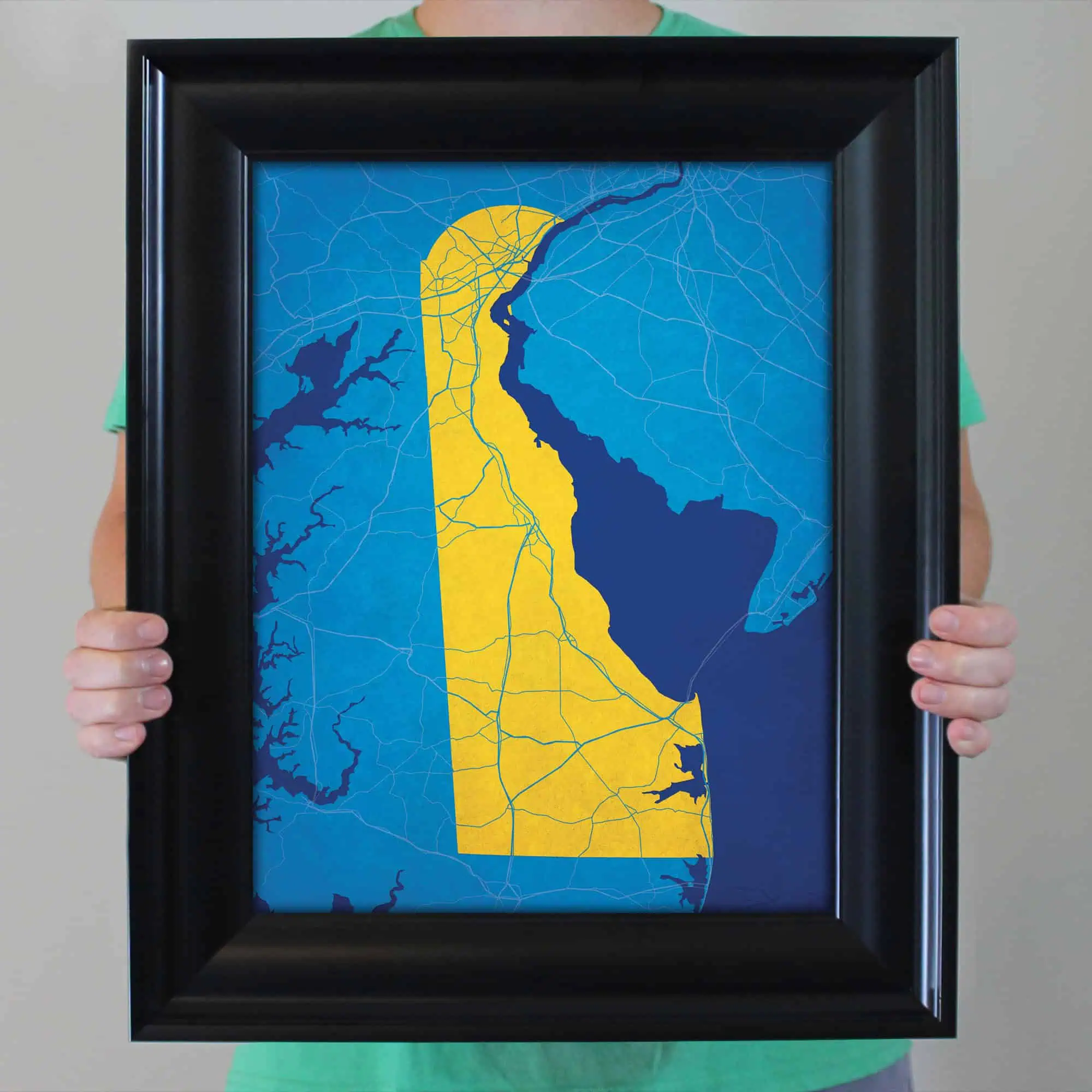 Detailed map of Georgia featuring major roads, lakes, and urban areas, framed and held by a person. Perfect for travel planning, navigation, and geographical reference.
