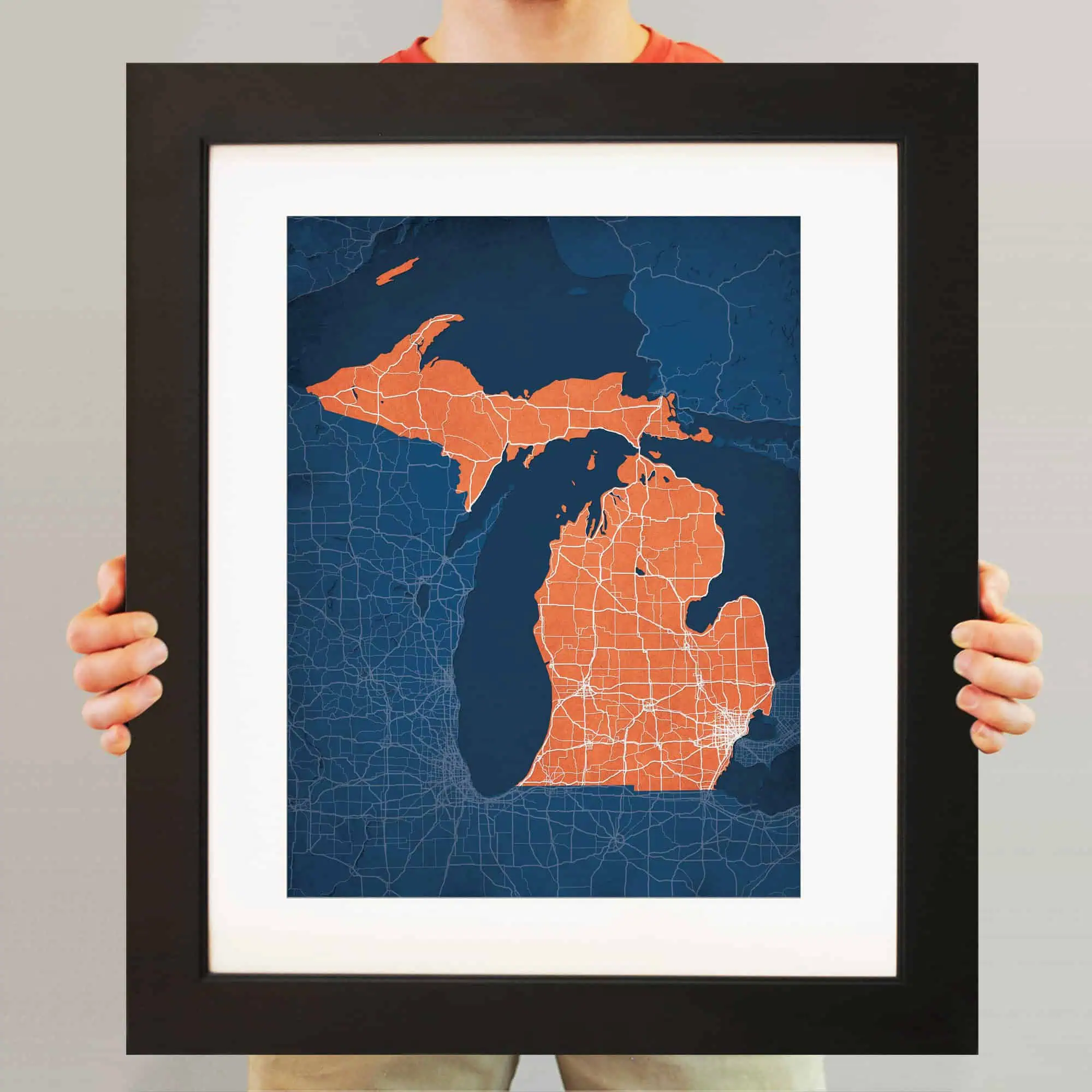 Detailed Michigan state map framed artwork showcasing roads and geographic features, ideal for navigation enthusiasts and map collectors.