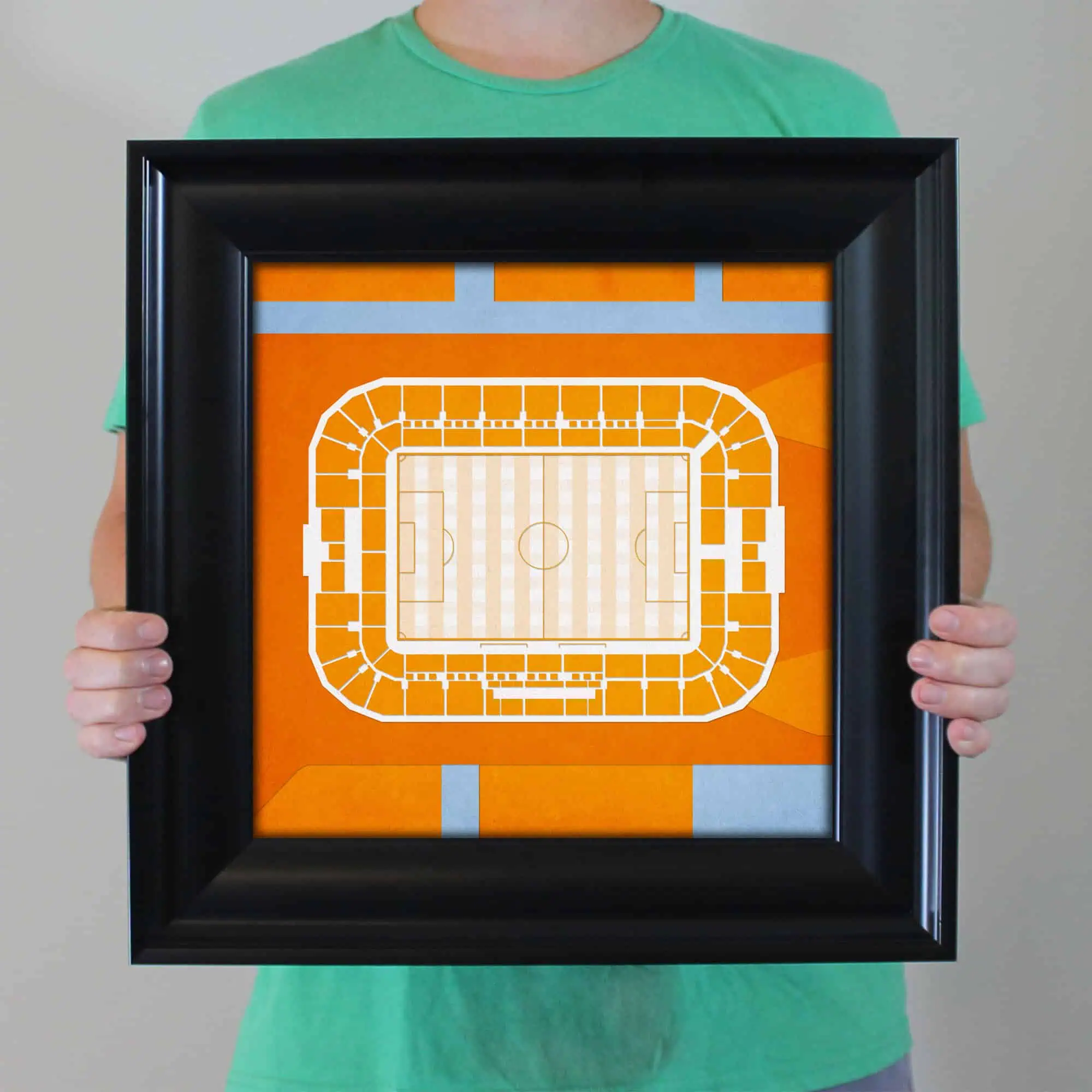 Detailed map of a sports stadium in an ornate black frame, featuring seating, pitch, and surrounding pathways, ideal for sports venue maps and stadium layouts.