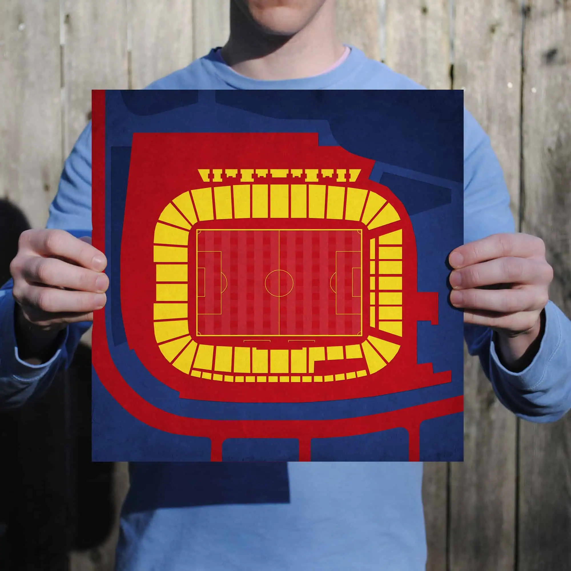 Colorful soccer stadium seating chart map held by person outdoors.