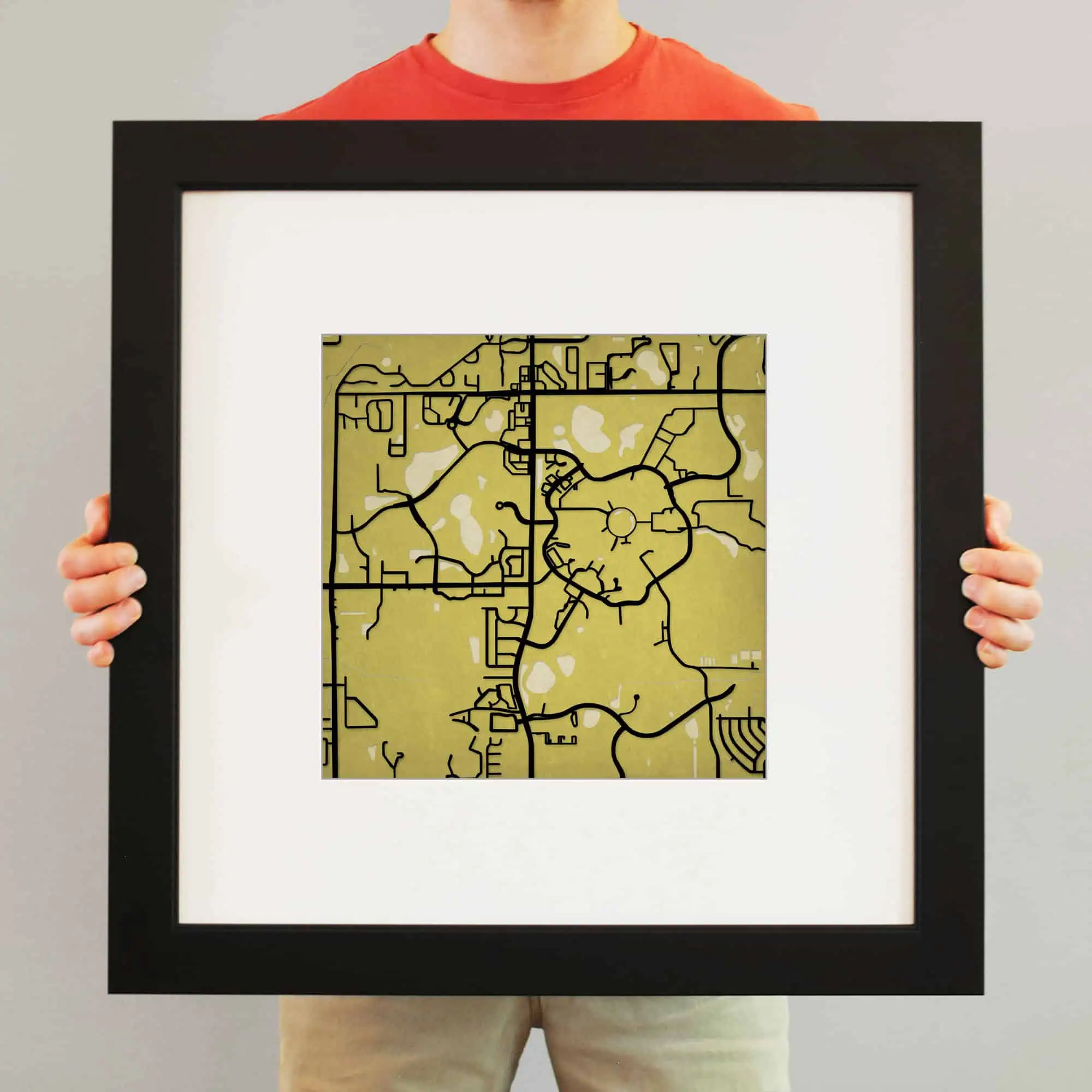 Vibrant city street map artwork mounted in a black frame, perfect for home or office decor, showcasing detailed urban planning and road layouts.