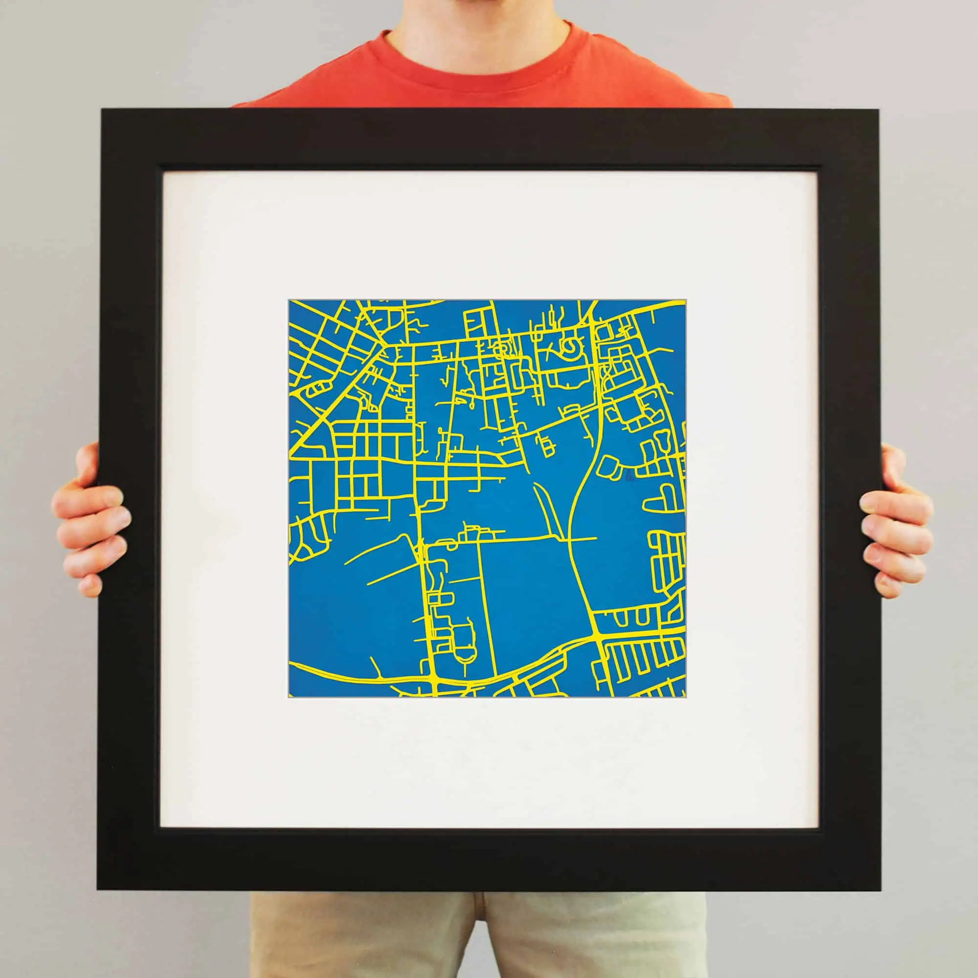 Vibrant blue and yellow map art framed for wall decor, showcasing detailed street layouts perfect for map enthusiasts and travelers, available at The Map Shop.