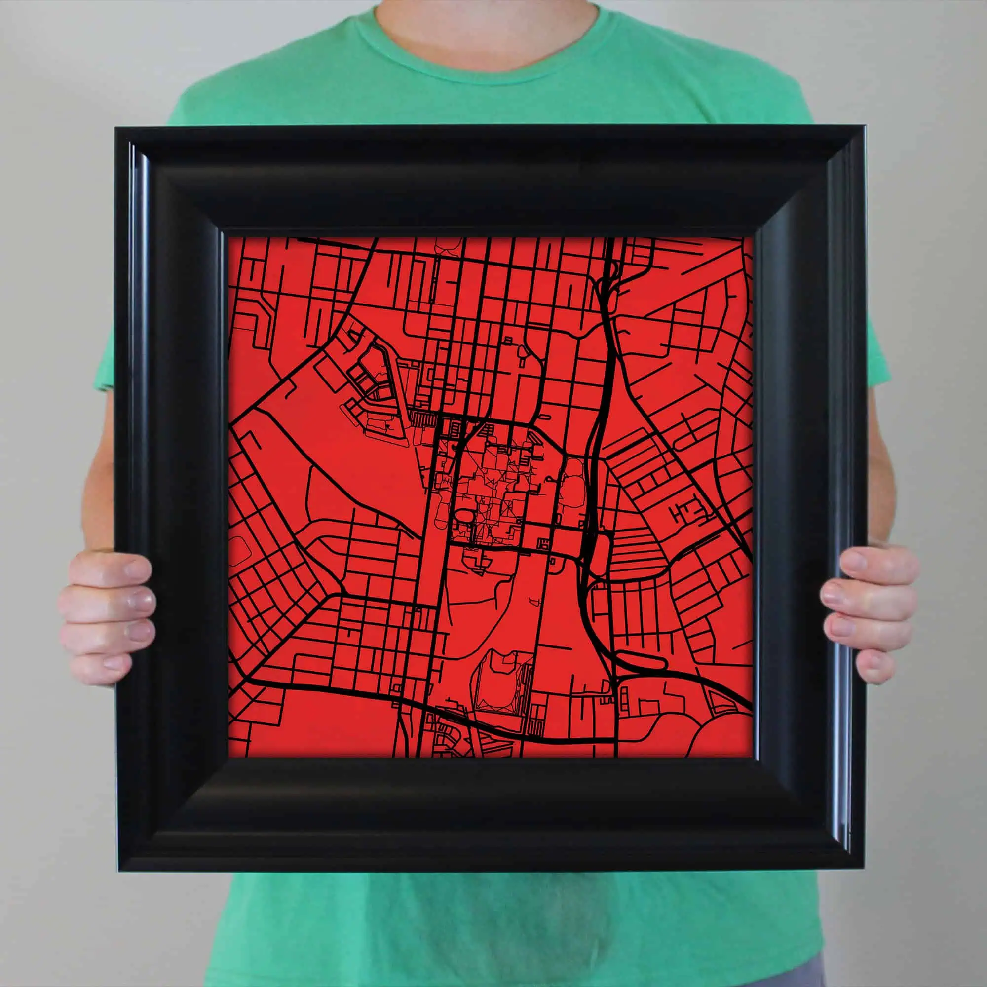 Detailed map of a city with black streets on a red background, framed in black, emphasizing geographic navigation, urban planning, and mapping solutions for travel and exploration enthusiasts.