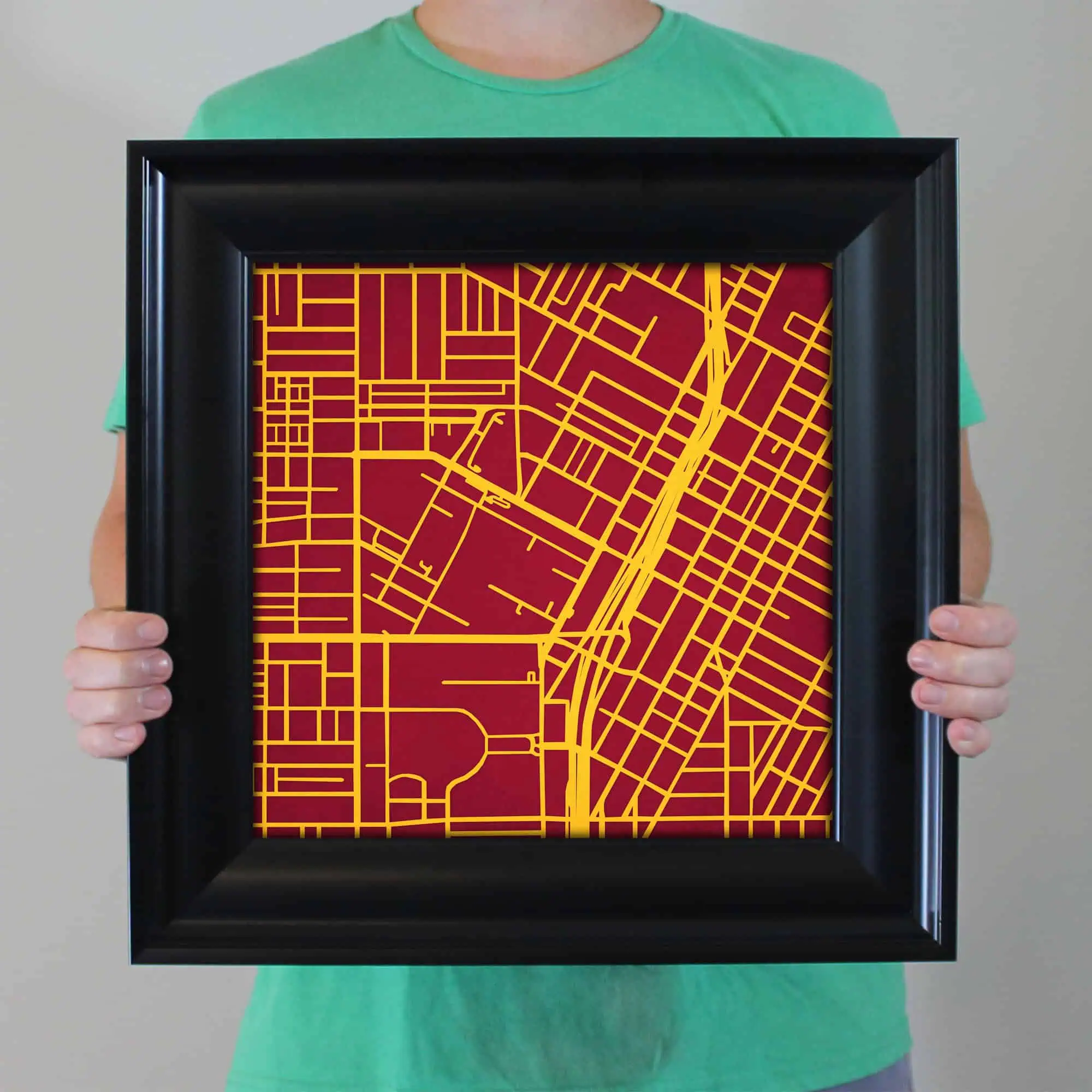 Vibrant city street map art framed in black, featuring detailed street layouts in yellow on a red background, perfect for home or office decor.
