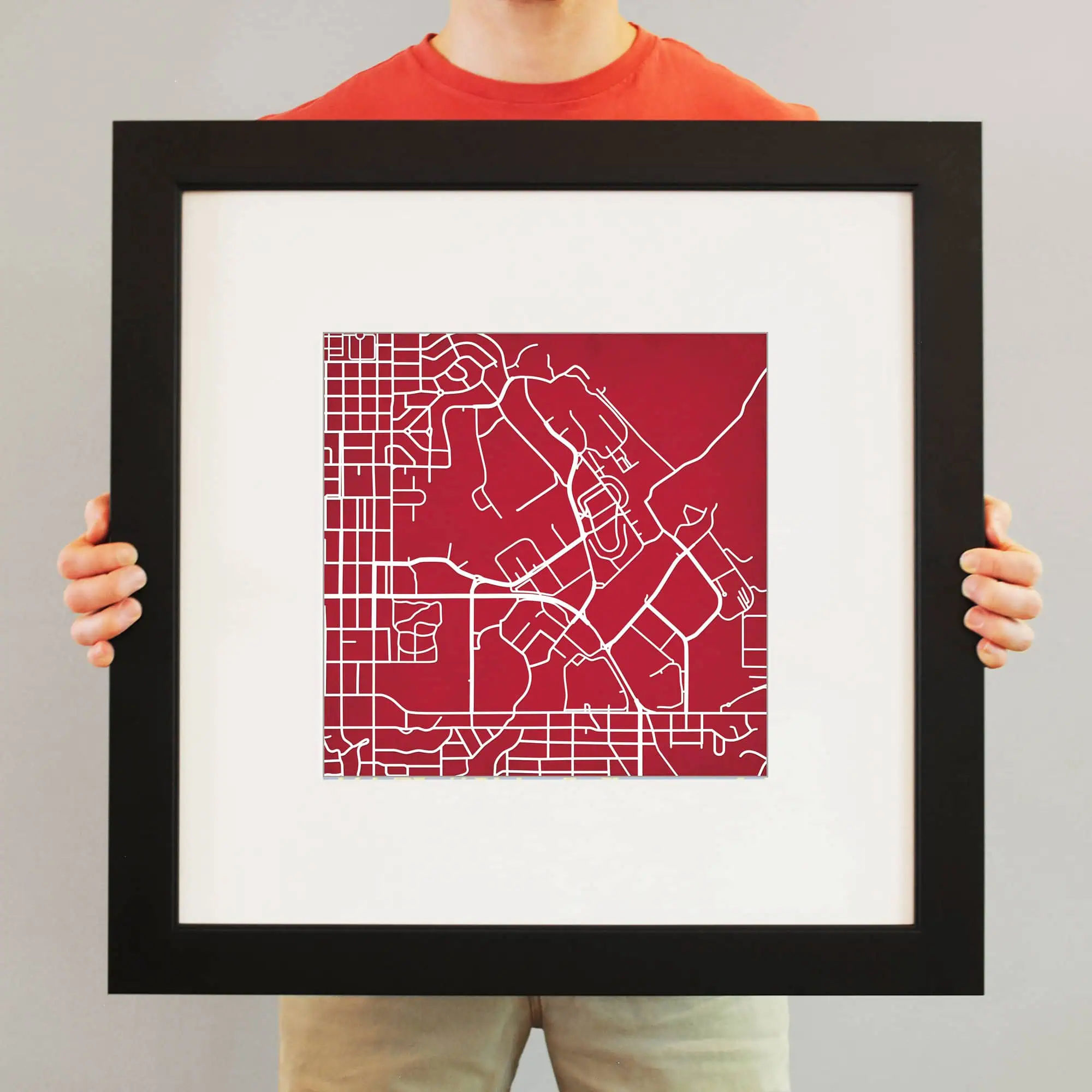Colorful urban street map art print in a sleek black frame, perfect for home or office decor, showcasing detailed city layout with vibrant red background, ideal for map enthusiasts and modern interior design.