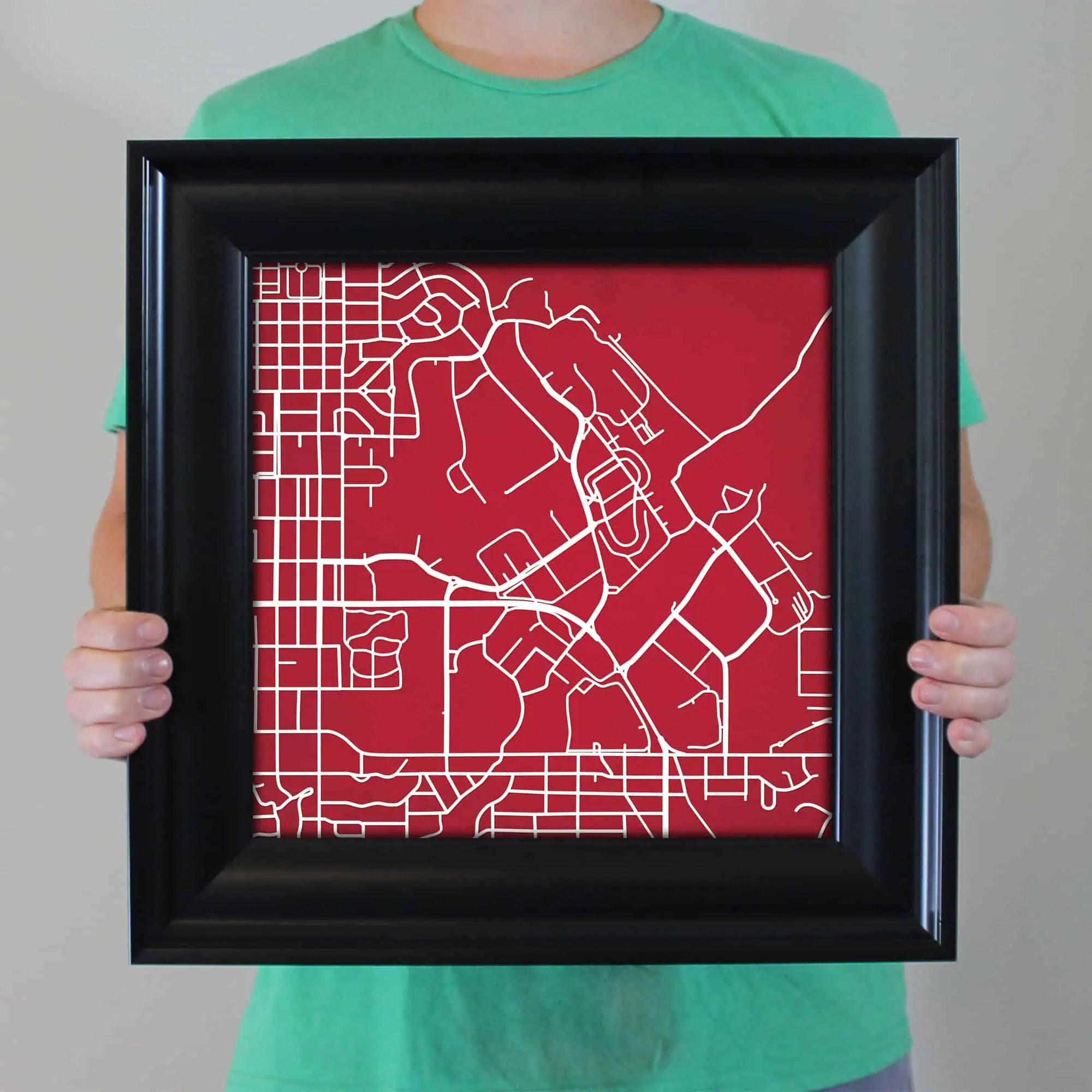 Minimalist city map artwork with a red background and white street outlines, perfect for urban decor and map enthusiasts.