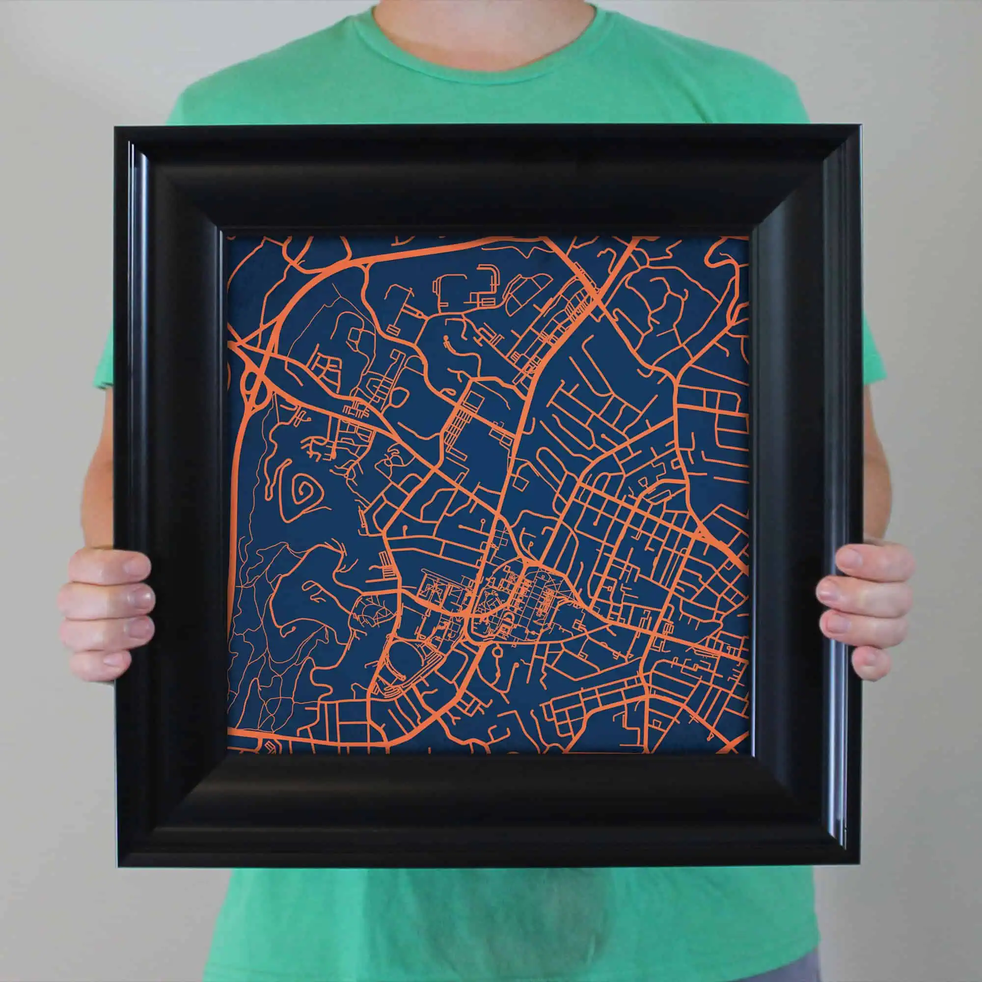 Detailed map artwork displayed within a black frame, showcasing the intricate street layout of an urban area. Perfect for map enthusiasts, home decor, or gift ideas from The Map Shop.